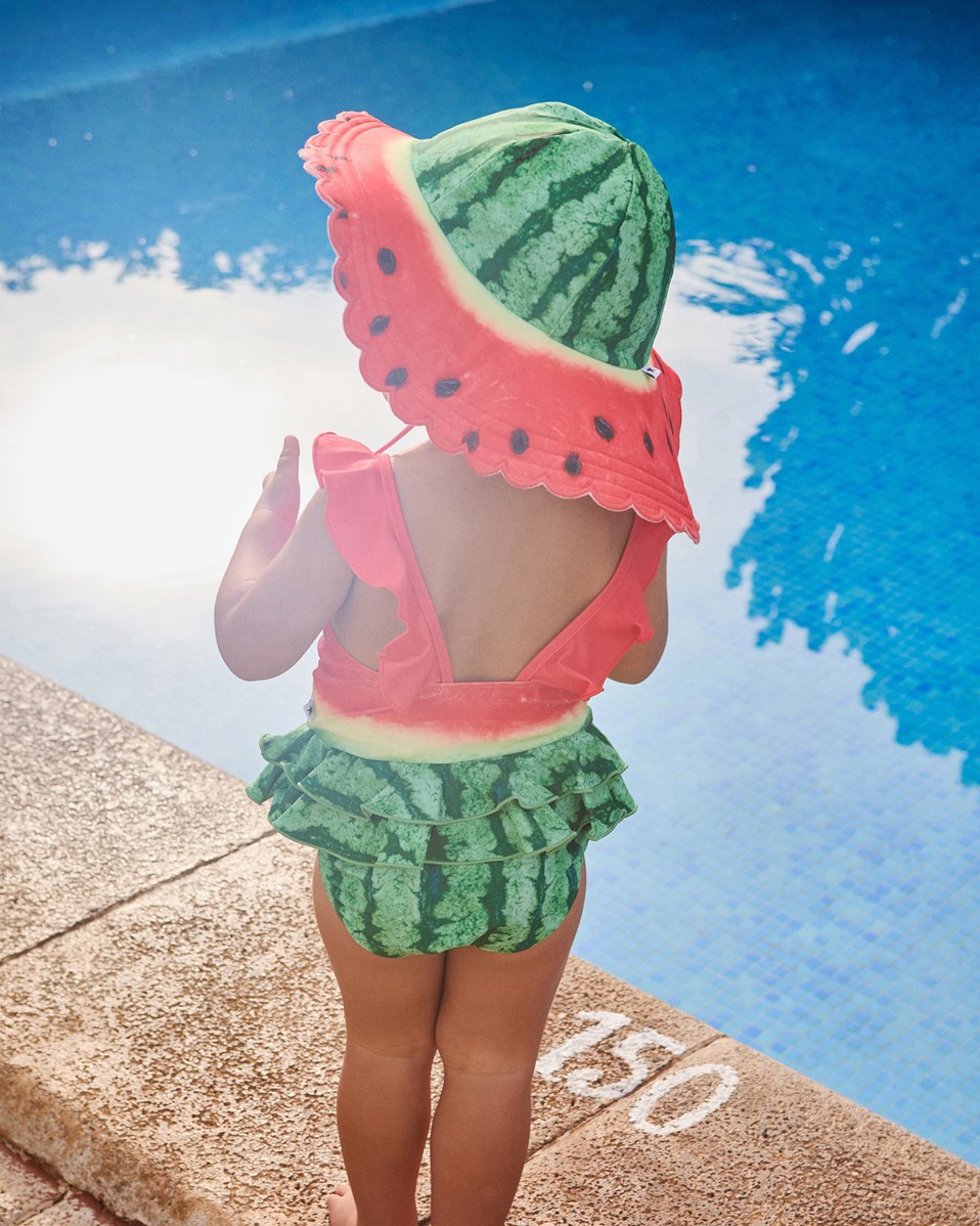 Nuka - Melon - Elastisk solhatt för barn i återvunnen polyester med UV-skydd 50+.