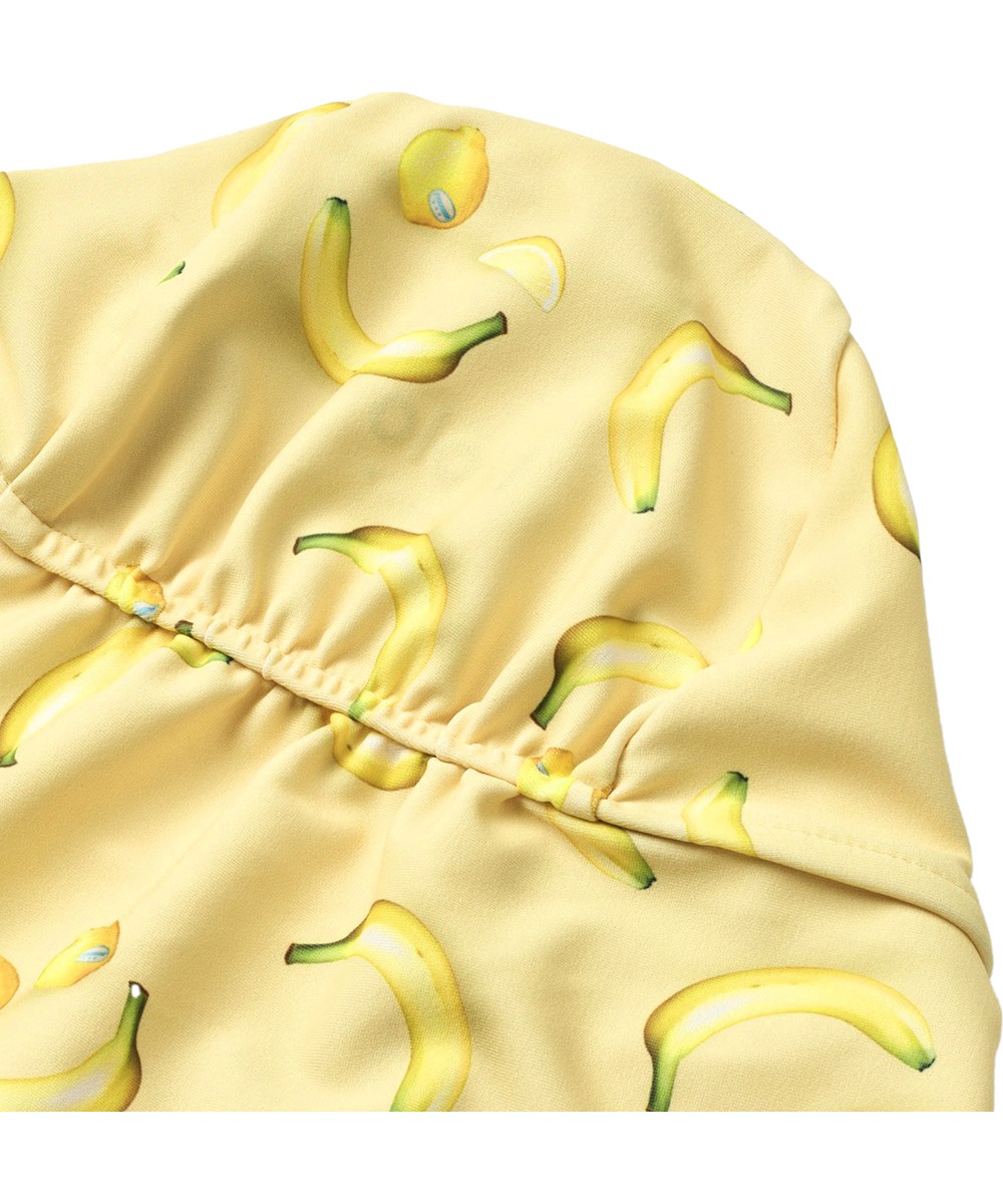 Nando - Lemon Banana - Rekbare zonnehoed met bananenprint voor kinderen gemaakt van gerecycled polyester met UV-bescherming 50+.