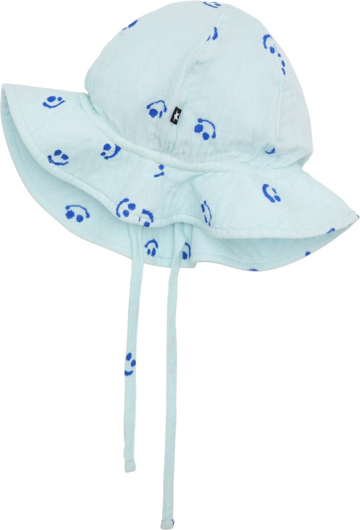 Noel - Aquarelle Smile - Light blue sun hat in lightweight, organic cotton weave with wavy brim and chin ties. The hat is in a navy, all over print of smiling faces