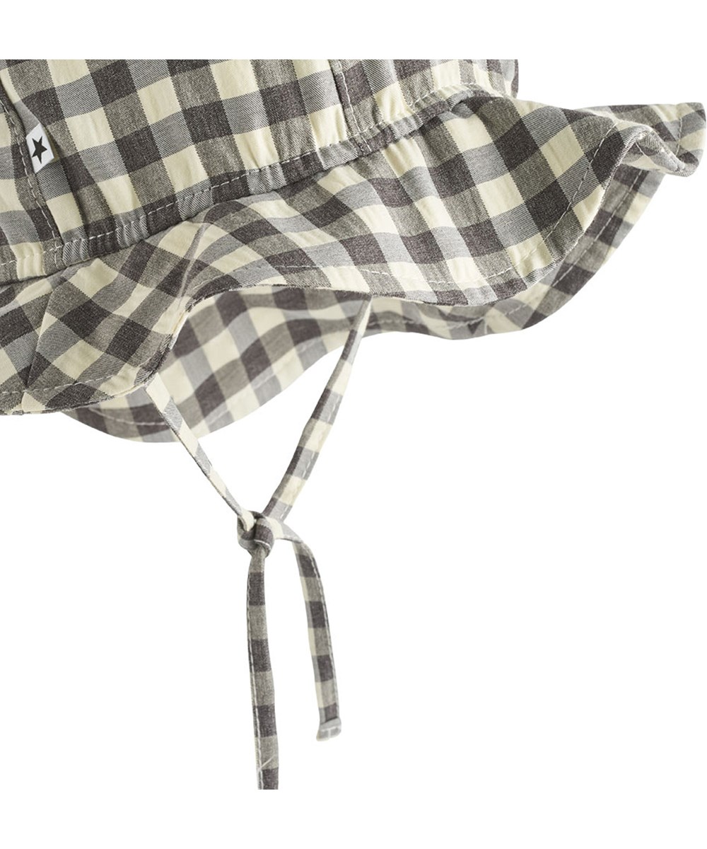 Noel - Sun Check - Black and white checkered baby hat with brim and ties.