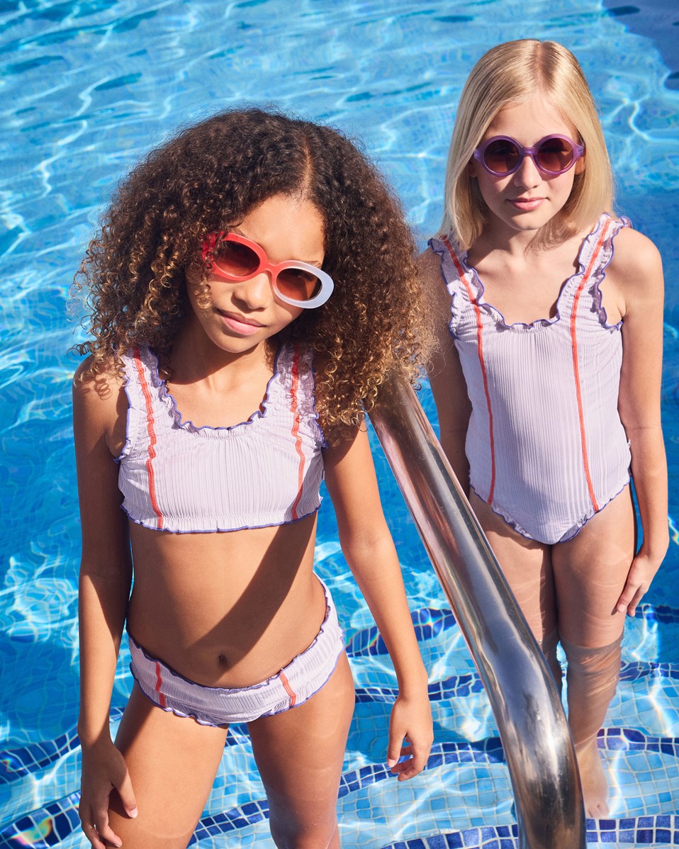 See - Purple Petal - Oval children's sunglasses in red and light lilac with tinted lenses, satin finish, and 100% UV protection.