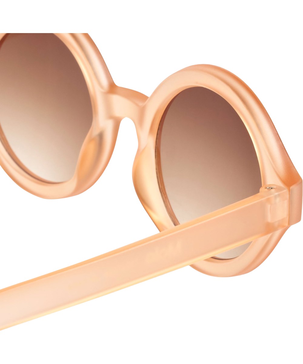 Shelby - Peach Fuzz - Round, orange sunglasses for children with UV protection.
