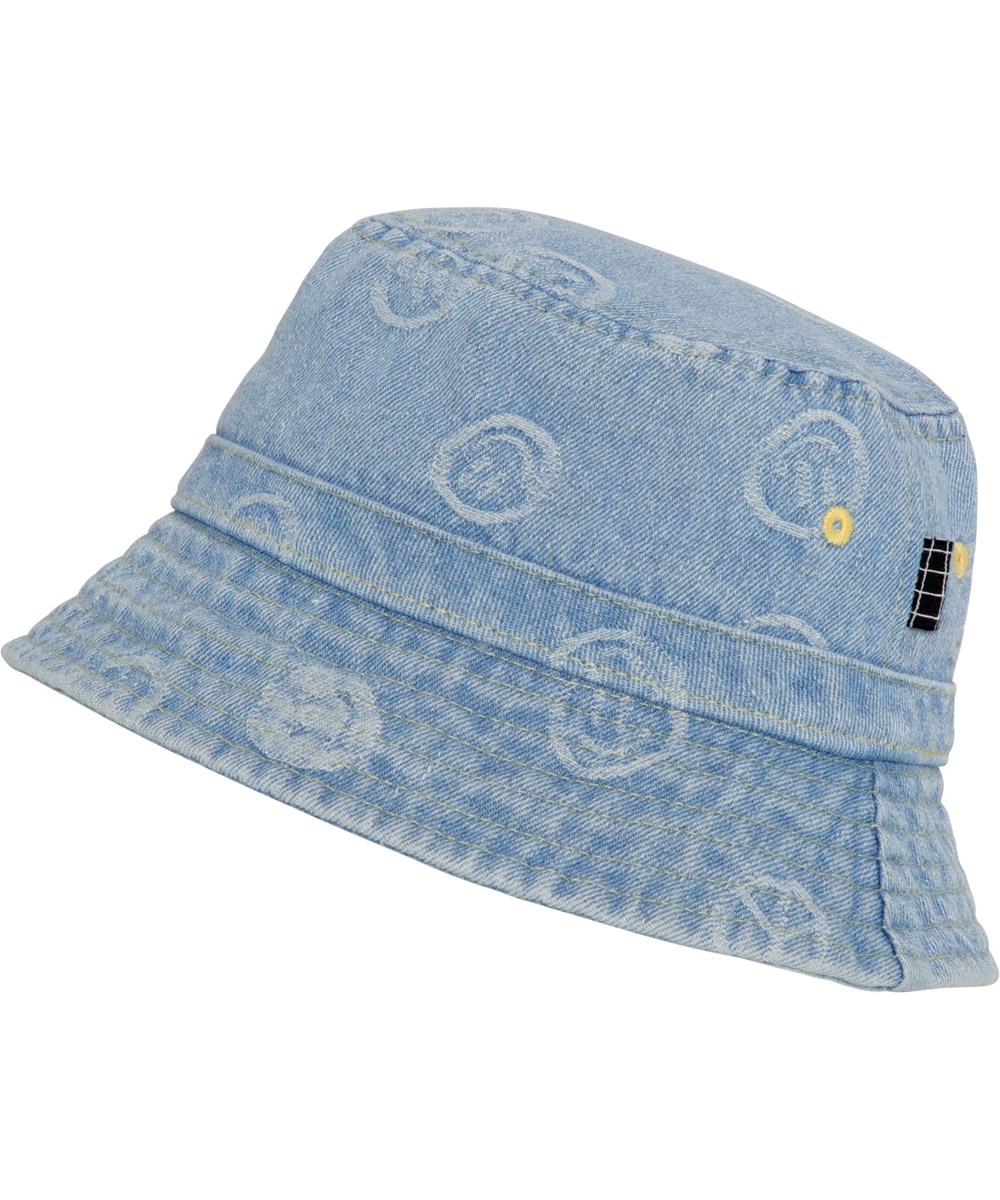 Siks - Happiness Light - Bucket hat in light coloured denim with small, smiling faces woven in. The hat has a turned down brim
