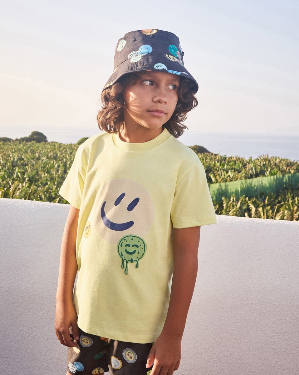 Niks - Smile All Over - Black bucket hat with smiling faces for children in recycled nylon with UV protection 50+.