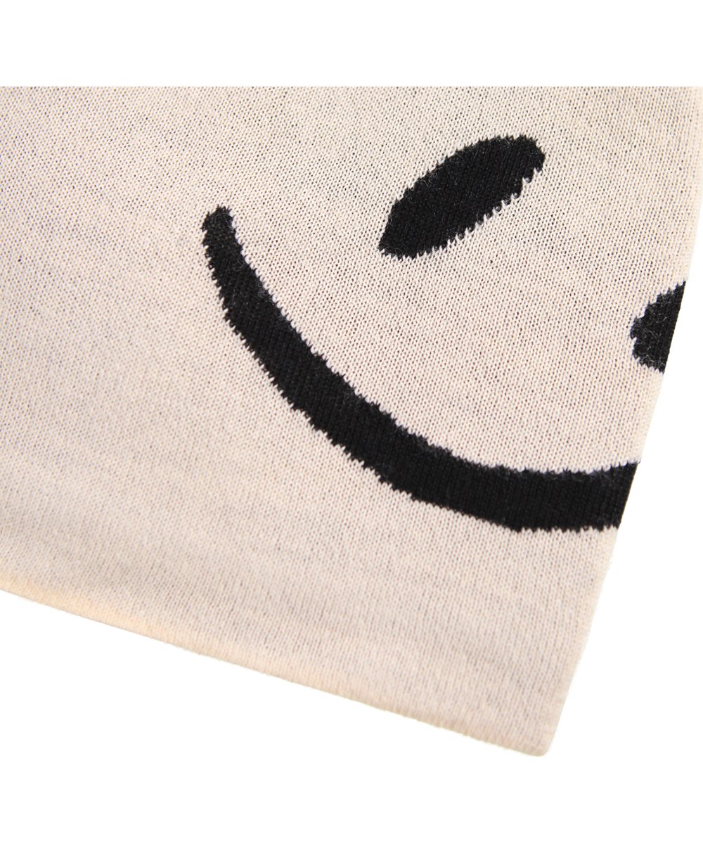 Colder - Vanilla - Cream-colored knitted beanie with black smiling faces for children.