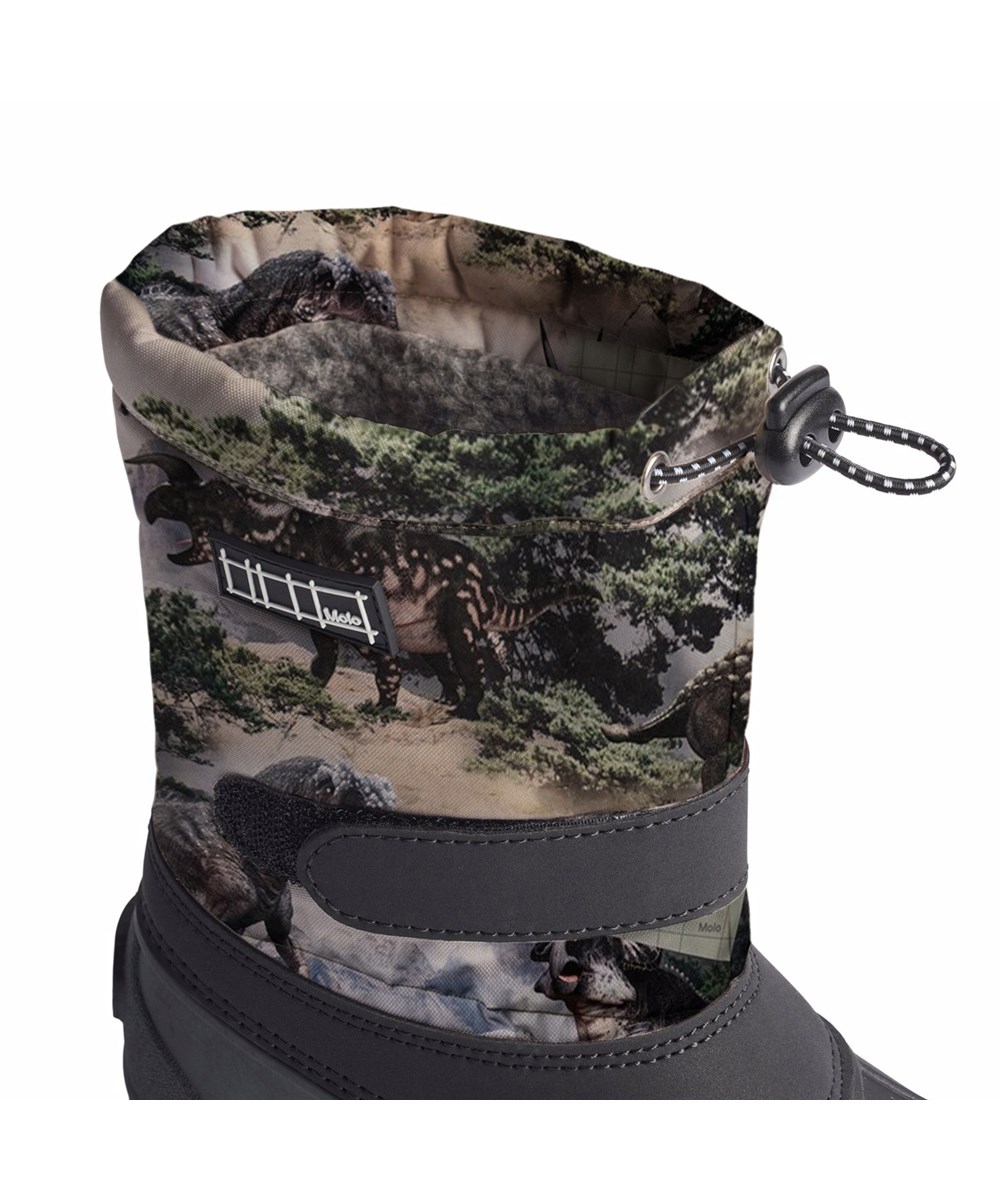 Driven - Rocky Dino - Praktische Winterstiefel für Kinder mit einem Dinosaurier-Druck und einer robusten und rutschfesten schwarzen Sohle.