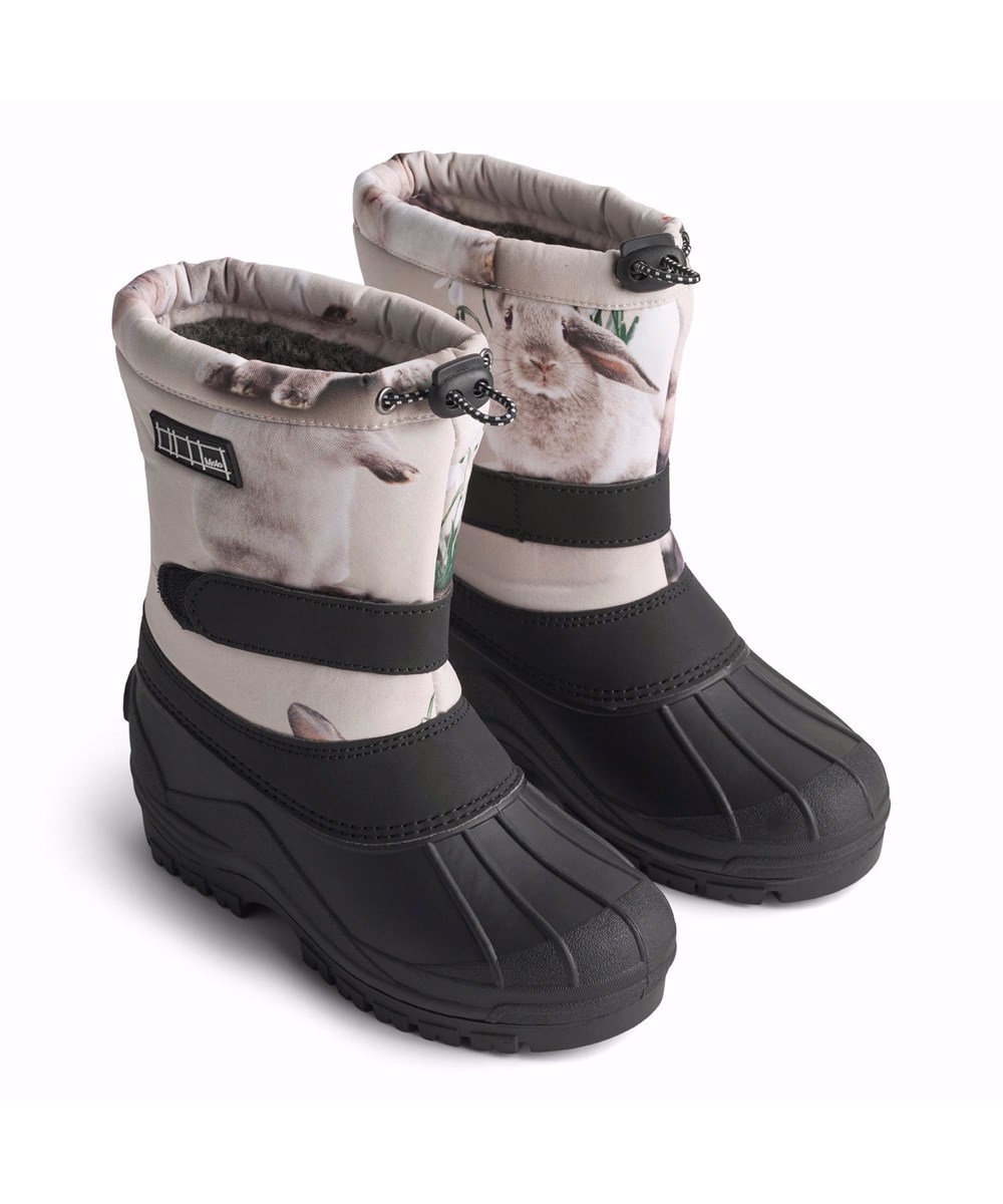 Driven - Winter Rabbits - Practical winter boots for children with a sturdy and non-slip black sole and a print of adorable rabbits among snowdrops on a grey background.