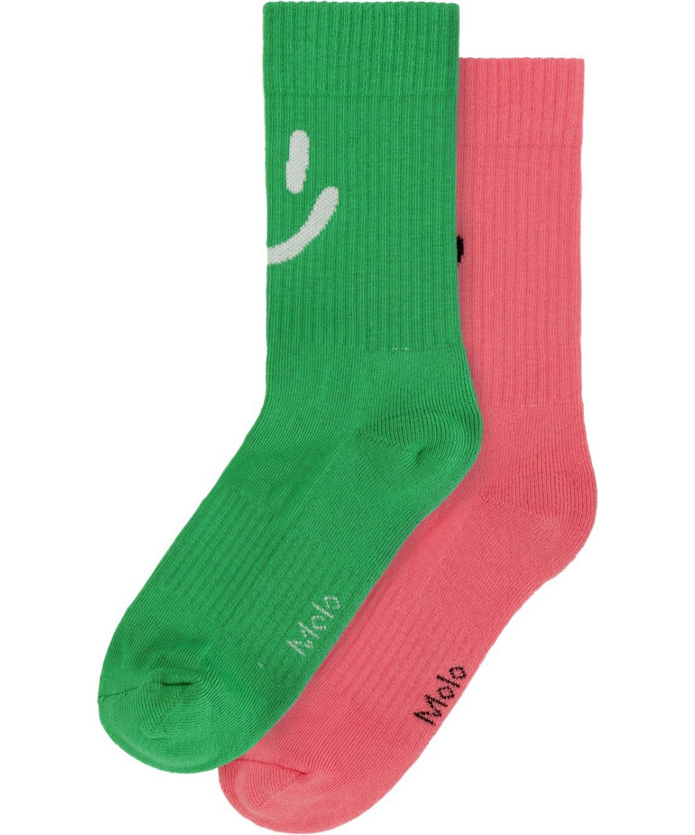 Norman - Confetti - 2er-Pack rote und grüne Socken mit Smiley-Motiv auf der Vorderseite aus einer weichen Baumwollmischung mit geripptem Schaft und Gummizug oben.