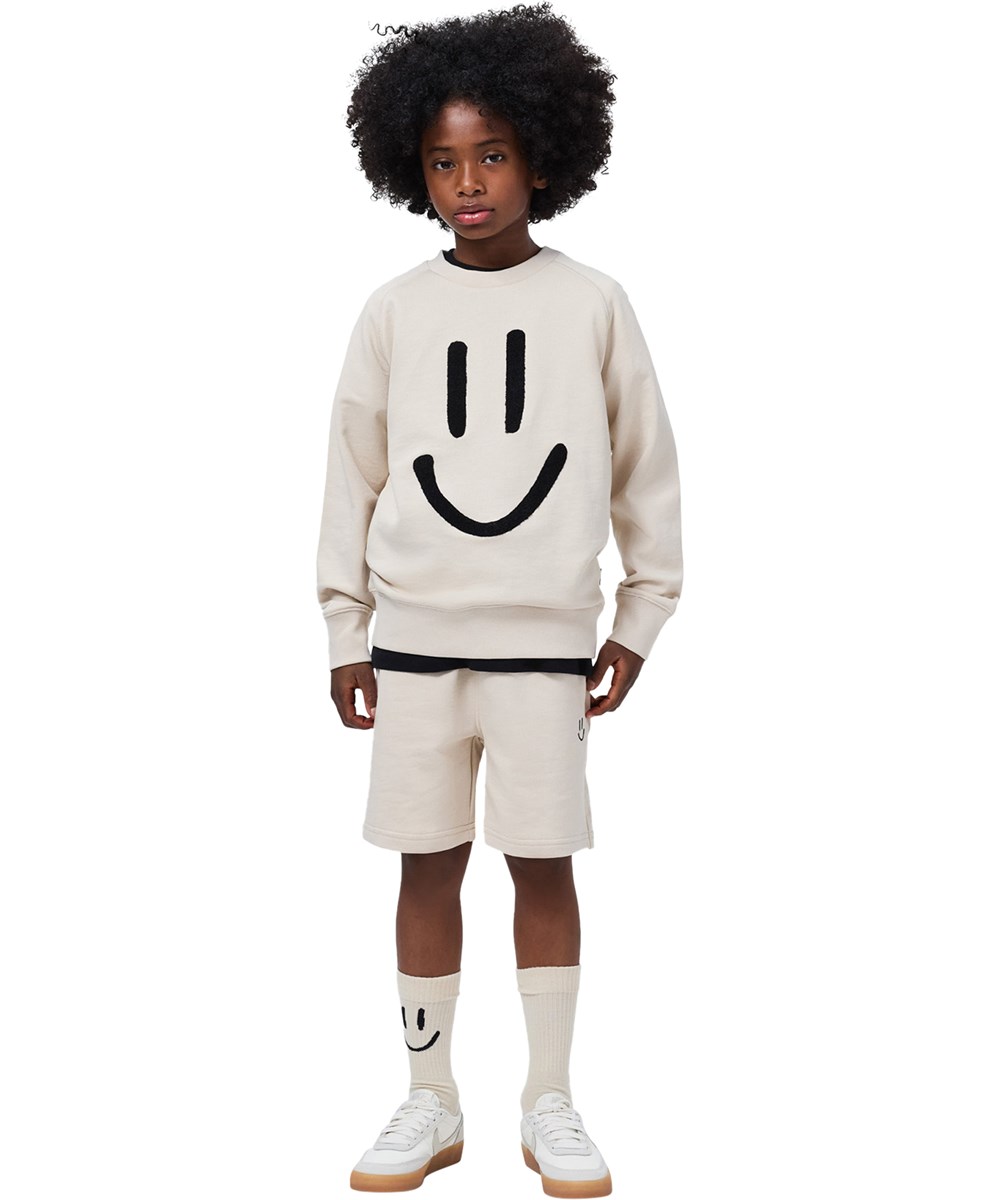 Norman - Sand Green - 2er-Pack Socken für Kinder aus grünem und cremefarbenem Baumwollstoff mit Lächelmotiv