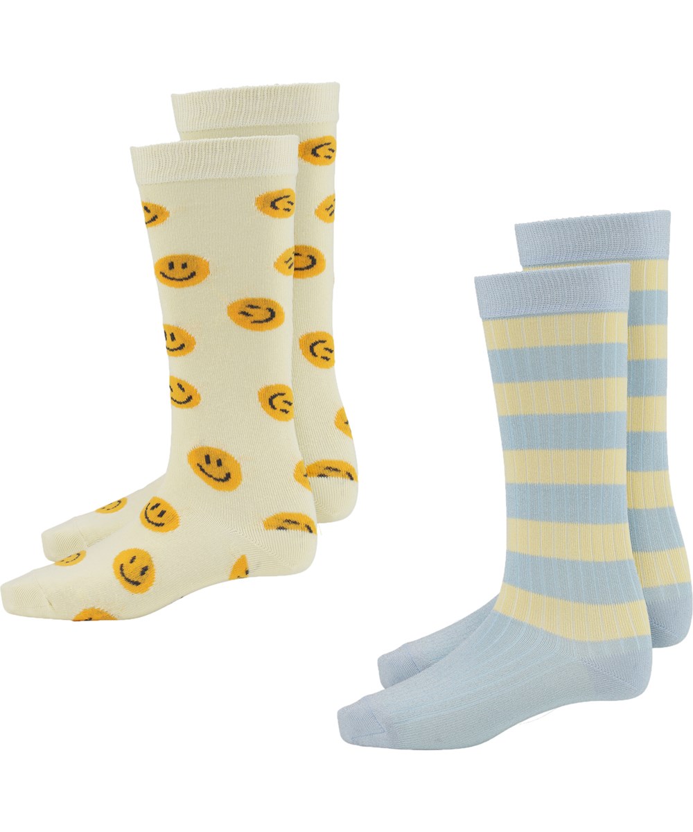 Norvina - Vanilla - Zwei Paar lange Socken mit Gesichtern und blauen und gelben Streifen