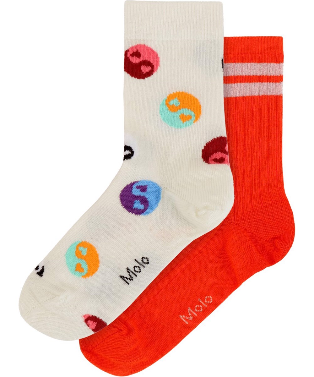 Nomi - Red Clay - 2-pack finely knit socks with one pair in yin/yang pattern and the other pair in red glitter with two white stripes on top 