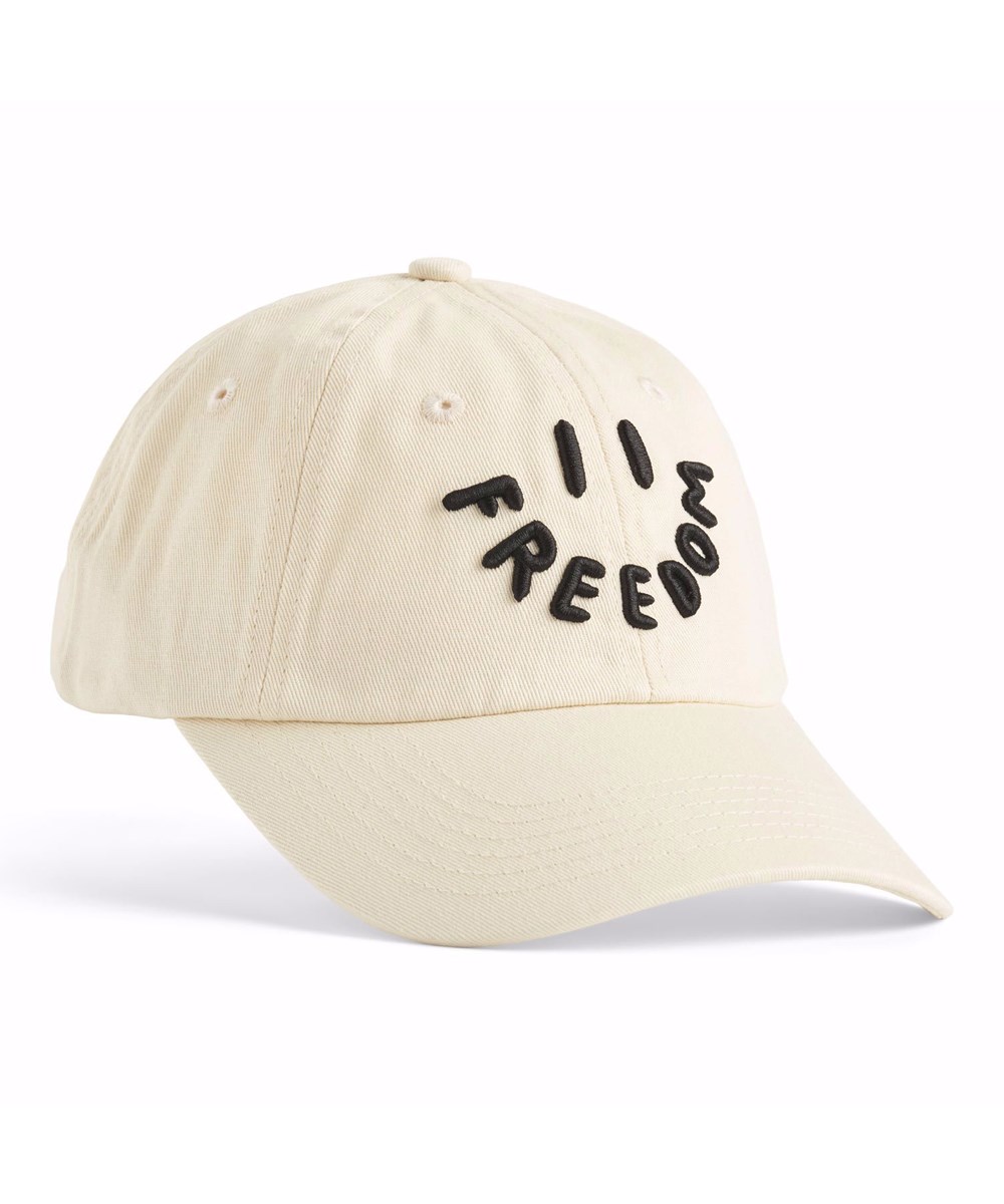 Steel - White Noise - Kasket i beige med et broderet smilende ansigt og teksten 'Freedom' broderet som mund til børn.