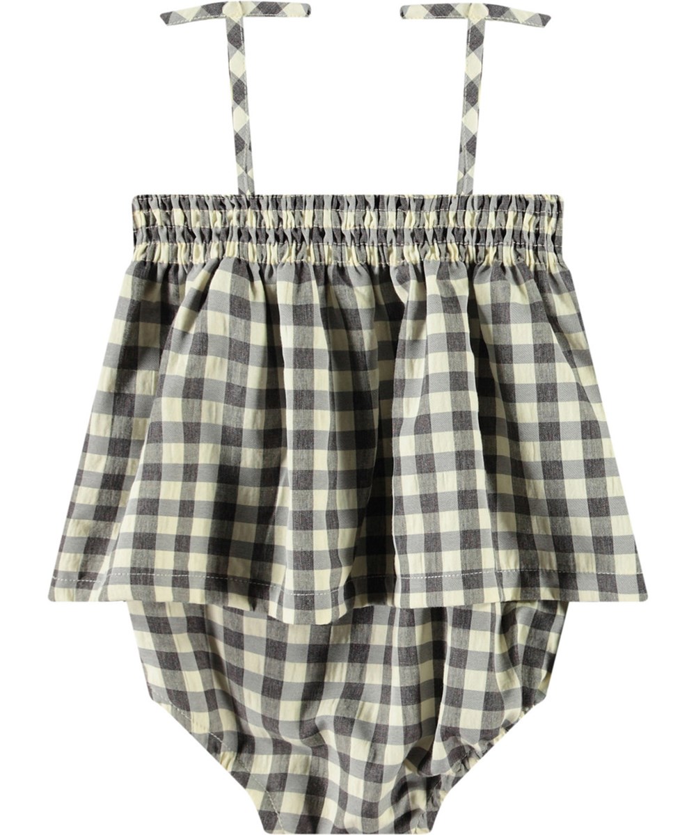 Flora - Sun Check - Rutig sommaroverall för baby i ekologisk bomull. Overallen har tunna axelband och inga ben.