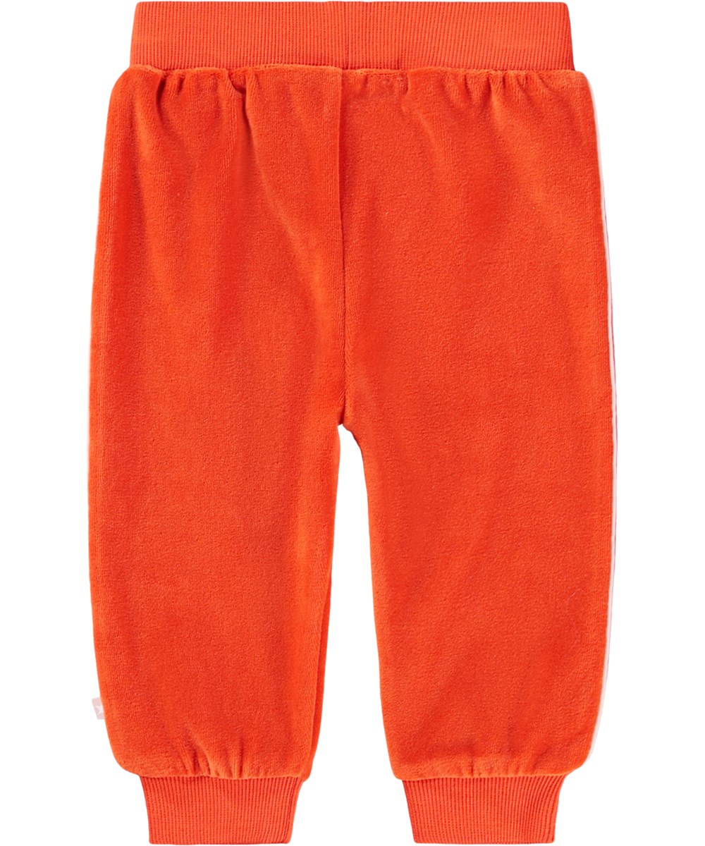 Shona - Rising Sun - Röda byxor till baby i ekologisk velour med orange ton.