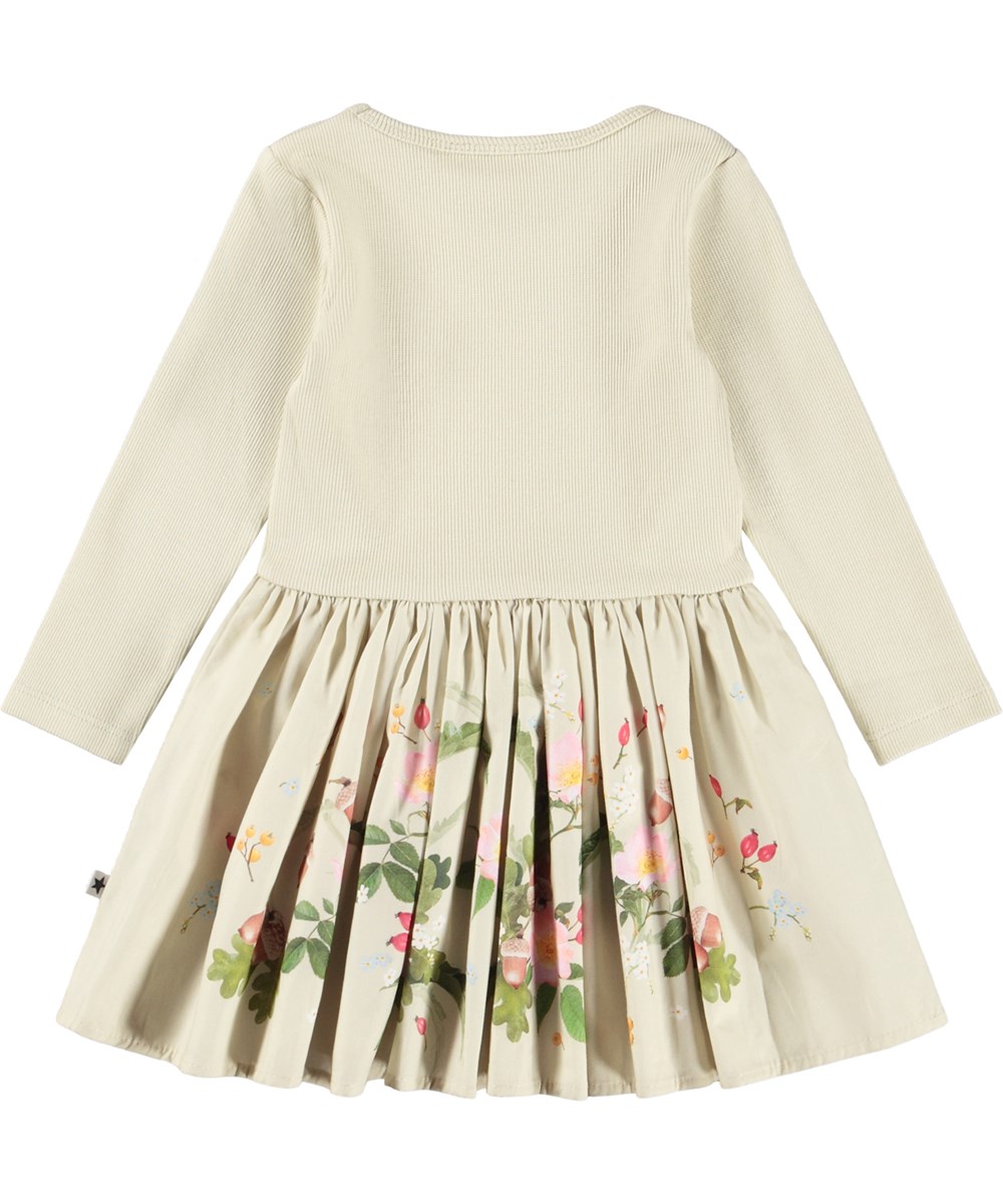 Candi - Floral Heart - Långärmad babyklänning i ekologisk bomull. Klänningen är ljusgrön med ett blommigt mönster.