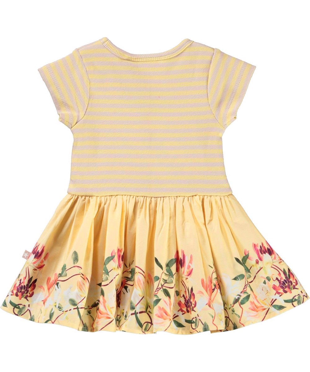 Carin - Honeysuckle Mini - Ljusgul klänning med peplum och blommor.