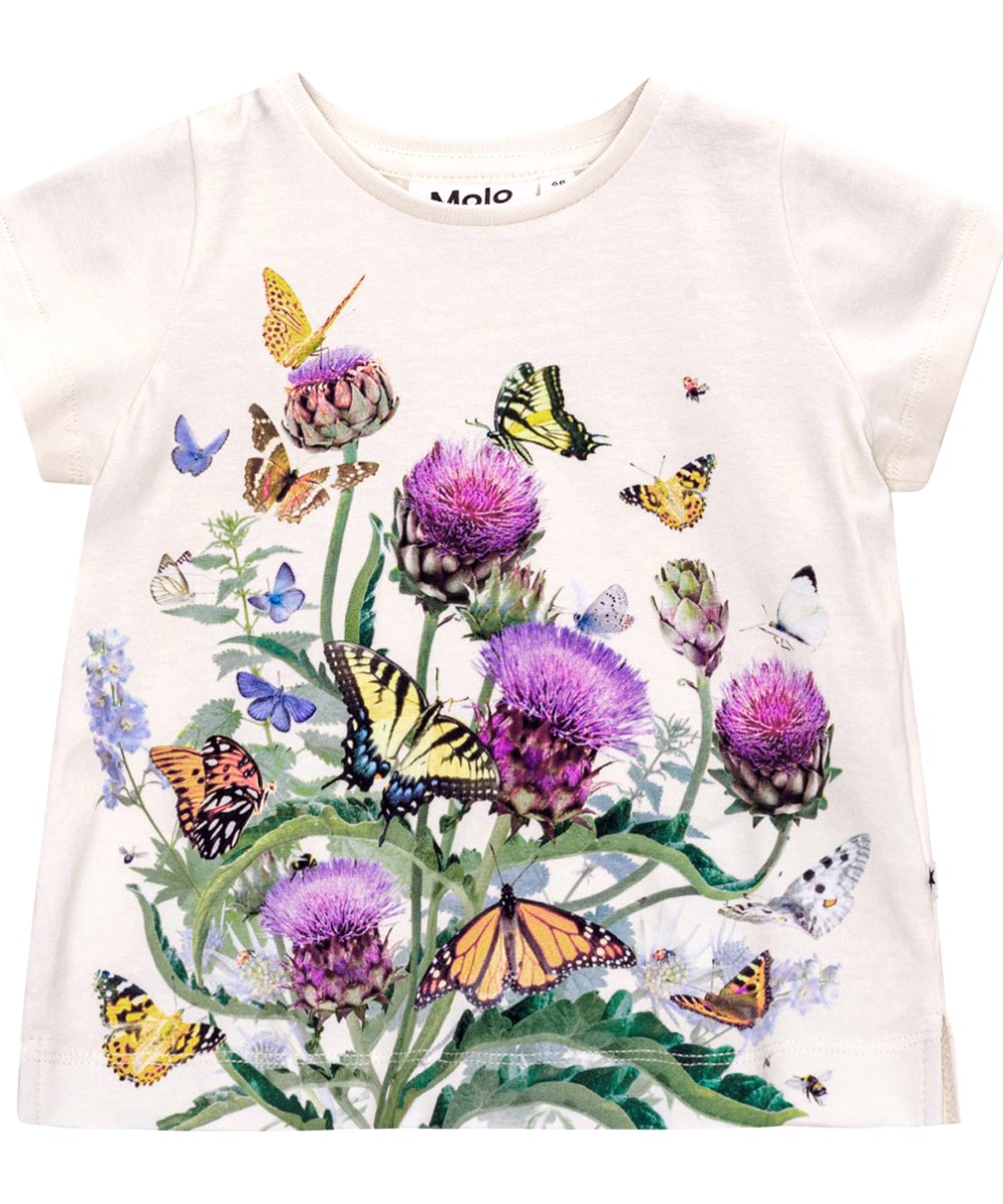 Elly - Garden Top - Vit T-shirt till baby i ekologisk bomull med fjärilar och kronärtskocksblommor. 