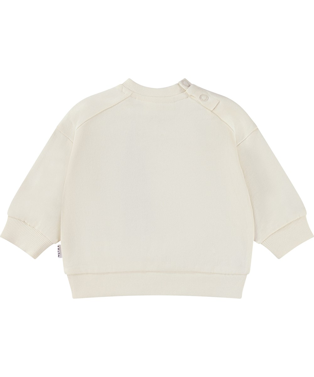 Dana - Pearled Ivory - Ekologisk vit babytröja med leende hjärtan.