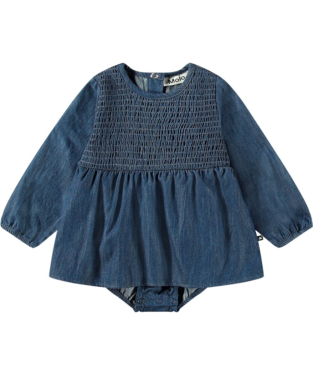 Francesca - Mid Blue Wash - Blue denim long-sleeved baby bodysuit made from organic cotton with smocked top and skirt.