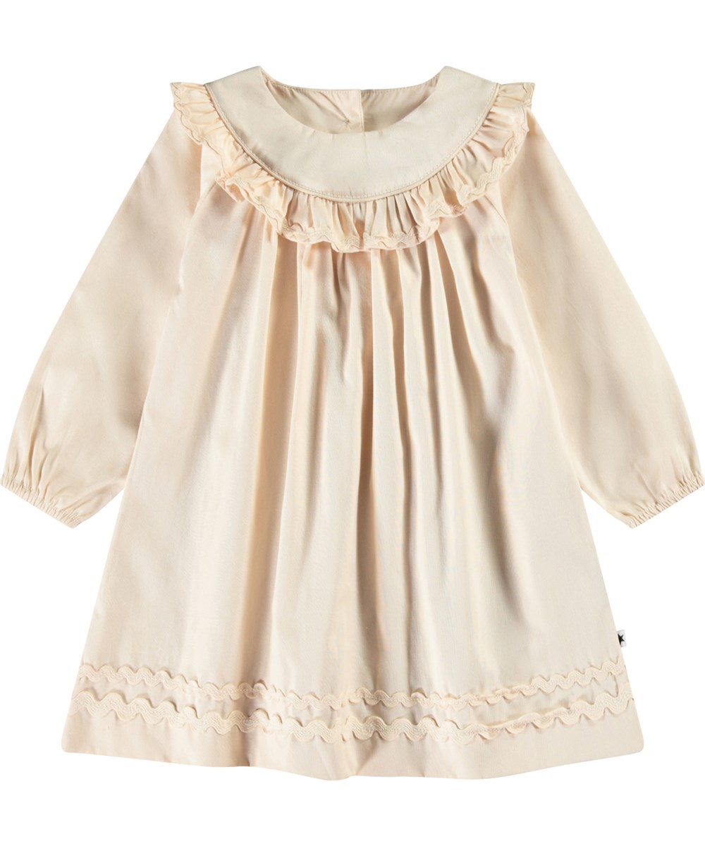Cailin - Brazilian Sand - Beige baby dress in organic cotton with ruffle details.