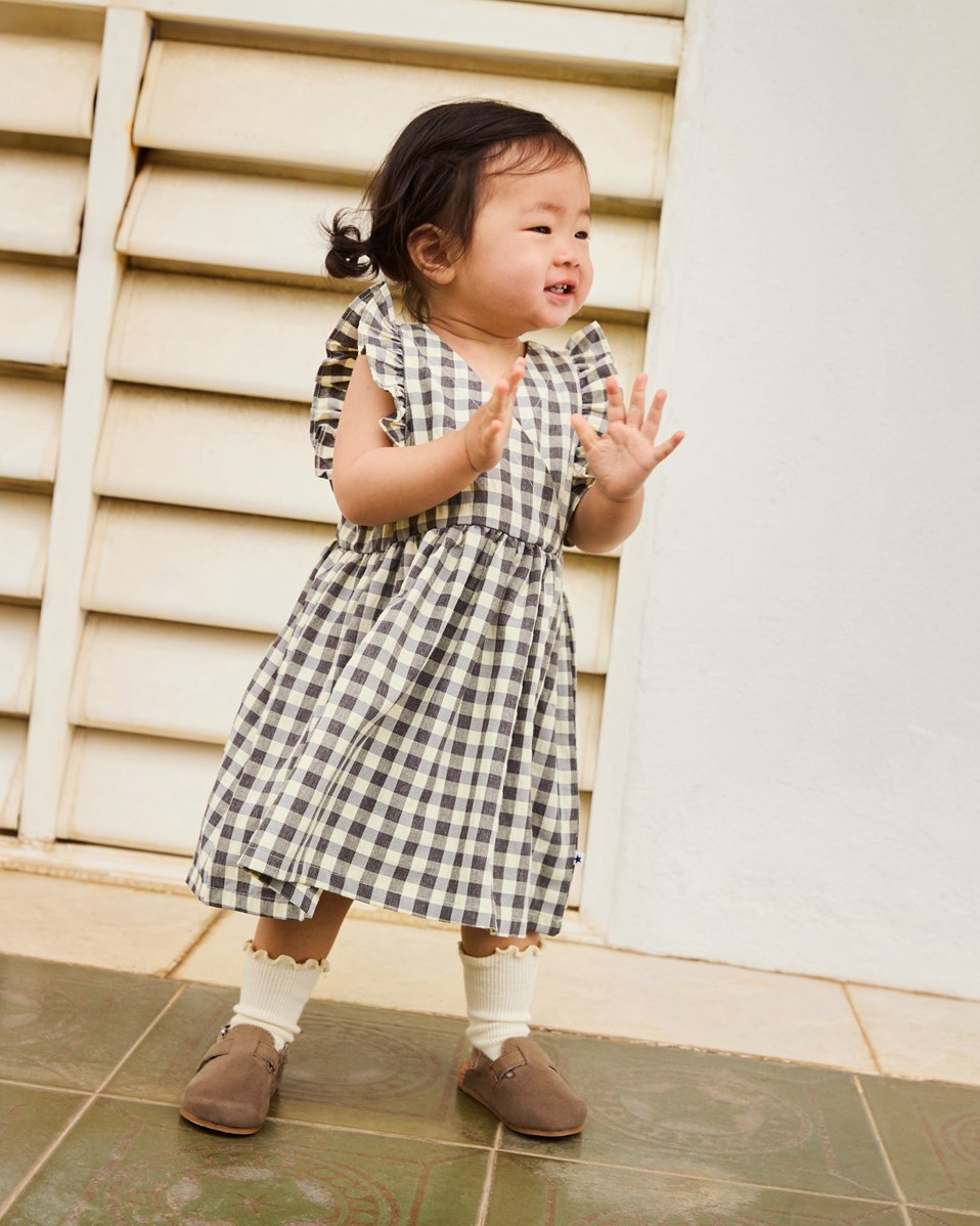 Callie - Sun Check - Black and white checkered dress in organic cotton with cute details for a baby.