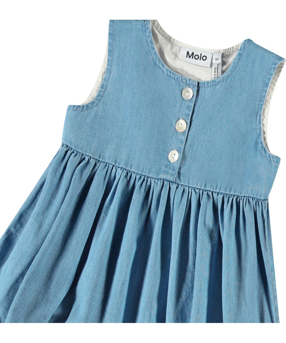 Calvina - Sky Indigo - Nice dress in organic cotton for a baby. The dress is made of chambray cotton with ruffle details.