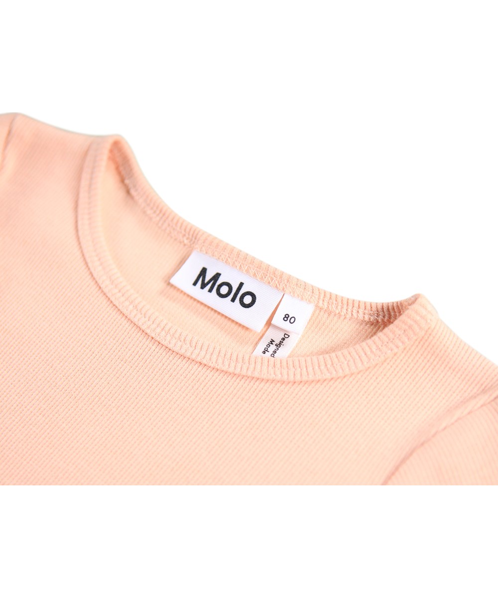 Candi - Rosey Bunny - Long-sleeved dress for the little ones made of organic cotton. The dress is peach-colored with a print of animals dressed in clothes and flowers.