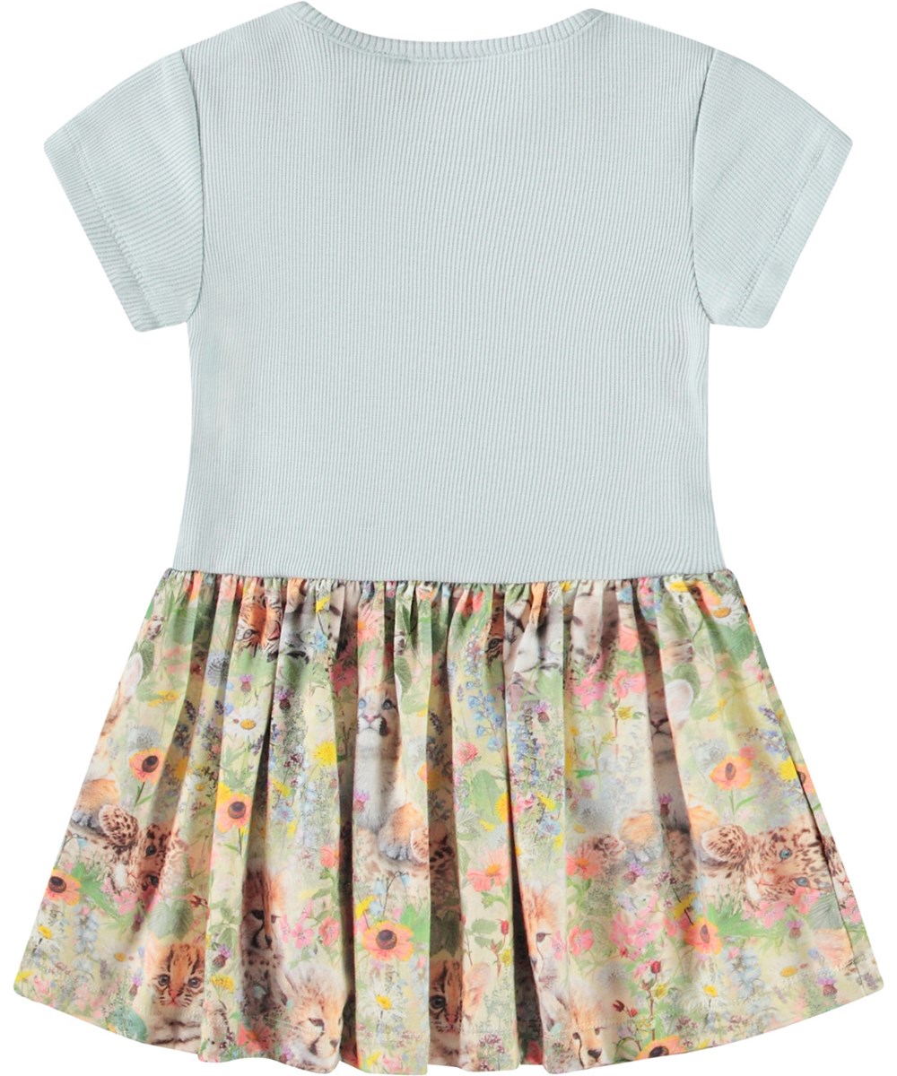 Catja - Meadow Cubs - Dress for baby in organic cotton. The dress is light blue with a colourful print of animal babies in a flower bed.