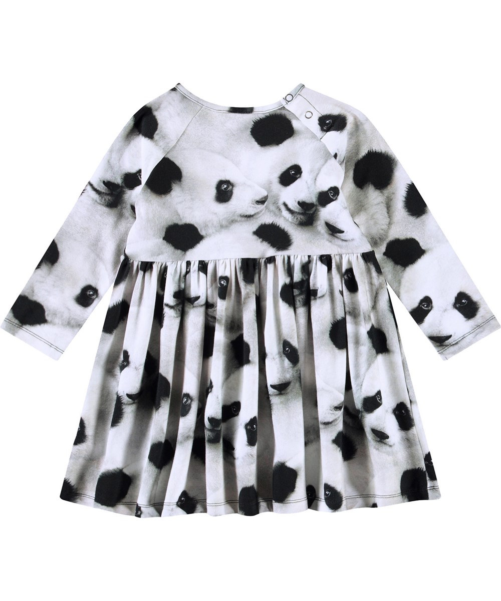 Charmaine - Giant Panda - Long-sleeved dress for baby in organic cotton. The dress features a print of panda faces.