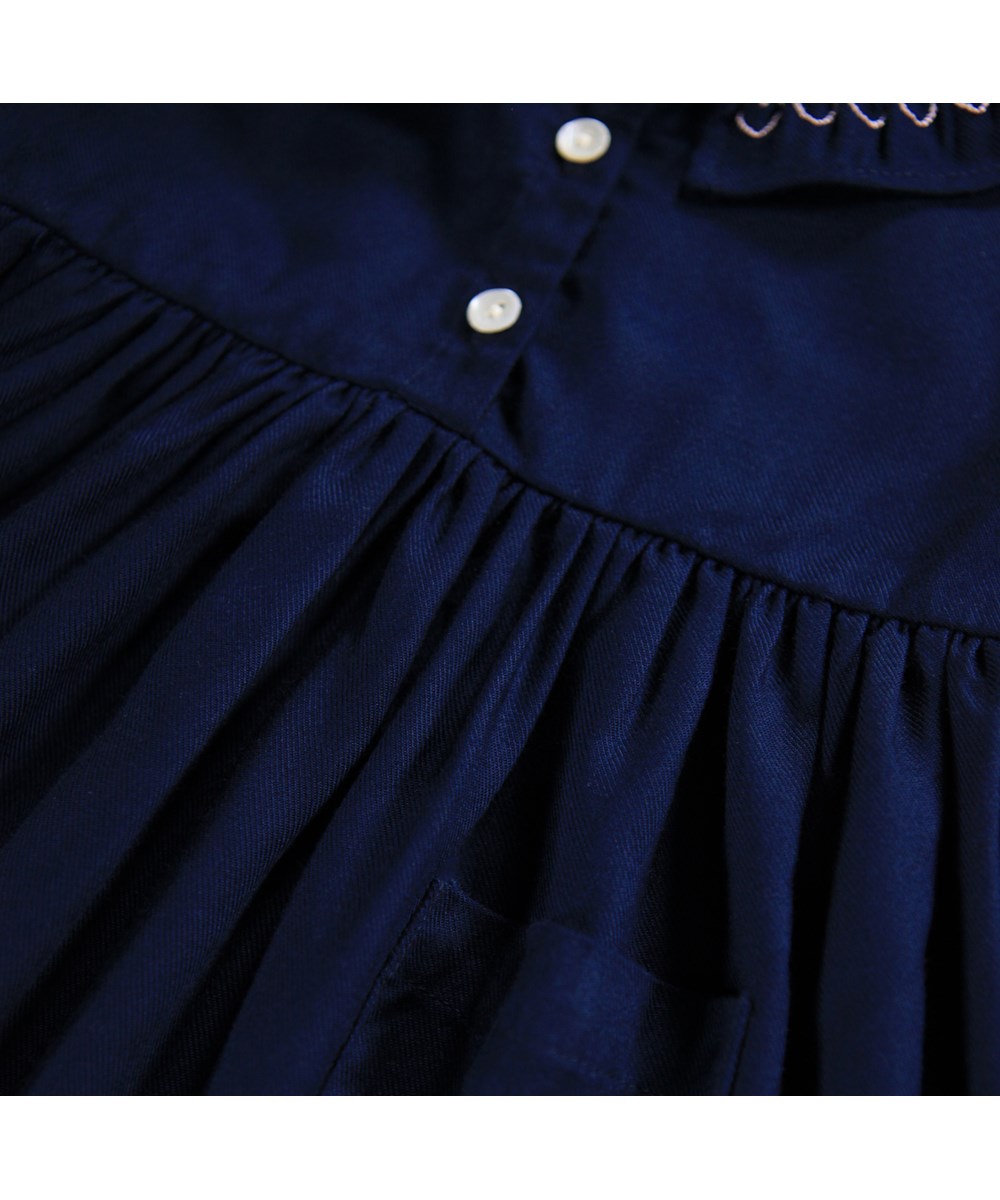Cindie - Galaxy Blue - Long-sleeved dark blue dress for the little ones made of viscose with colorful smock details.