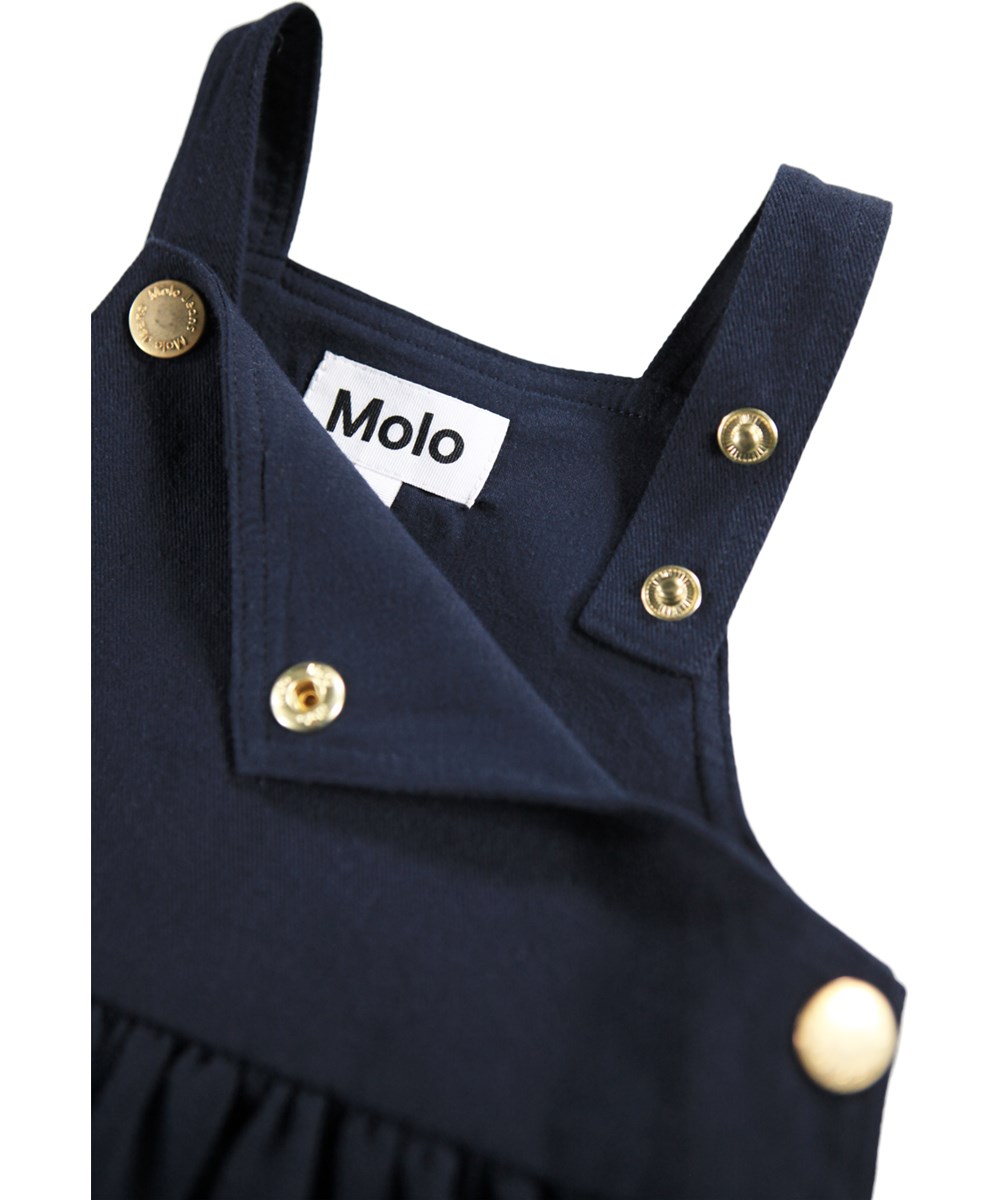 Colleena - Galaxy Blue - Nice dark blue pinafore dress for the little ones made of cotton with an embroidery of flowers and nuts.