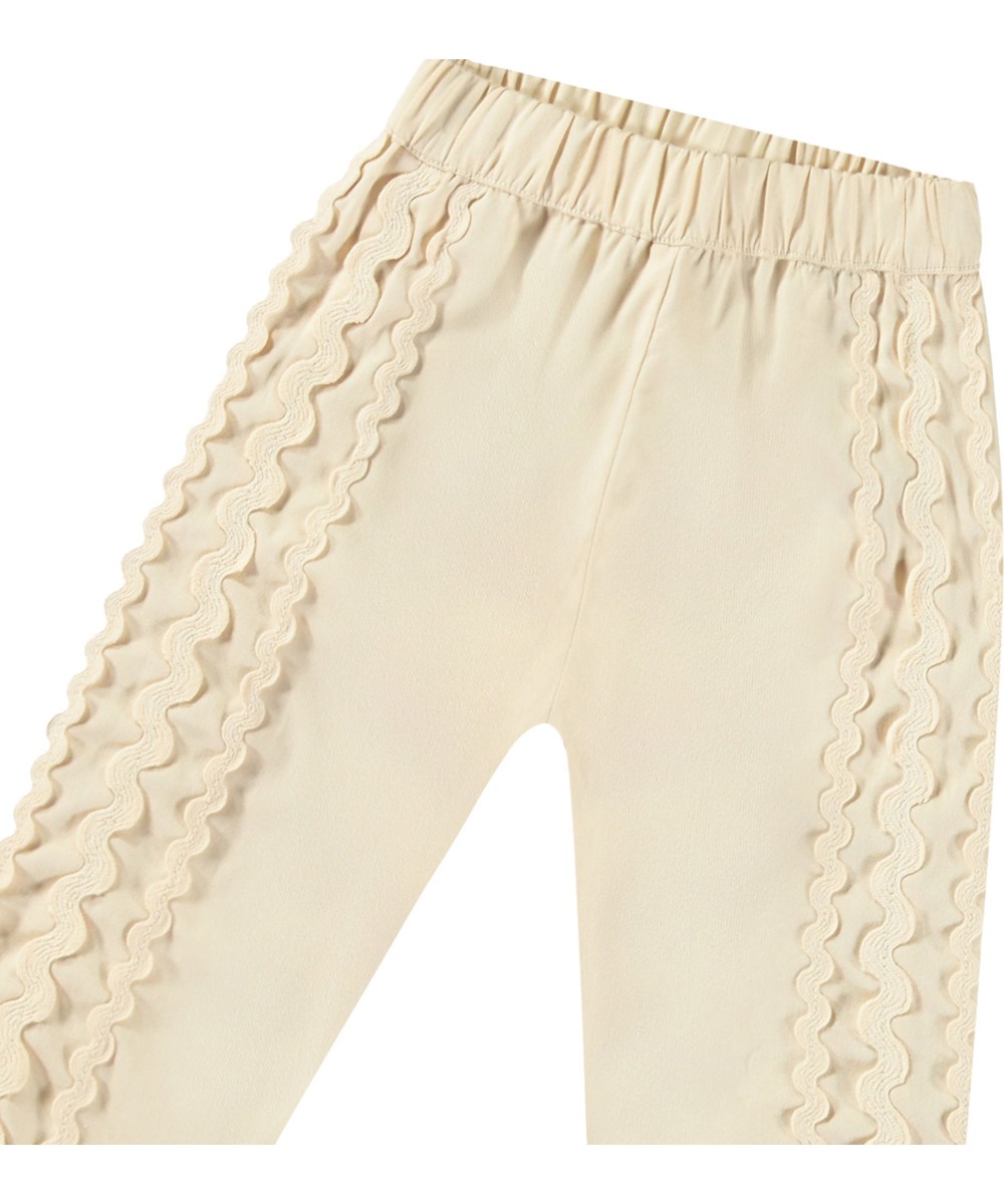Sally - Brazilian Sand - Organic cotton summer pants for babies. Sand-coloured with delicate details.