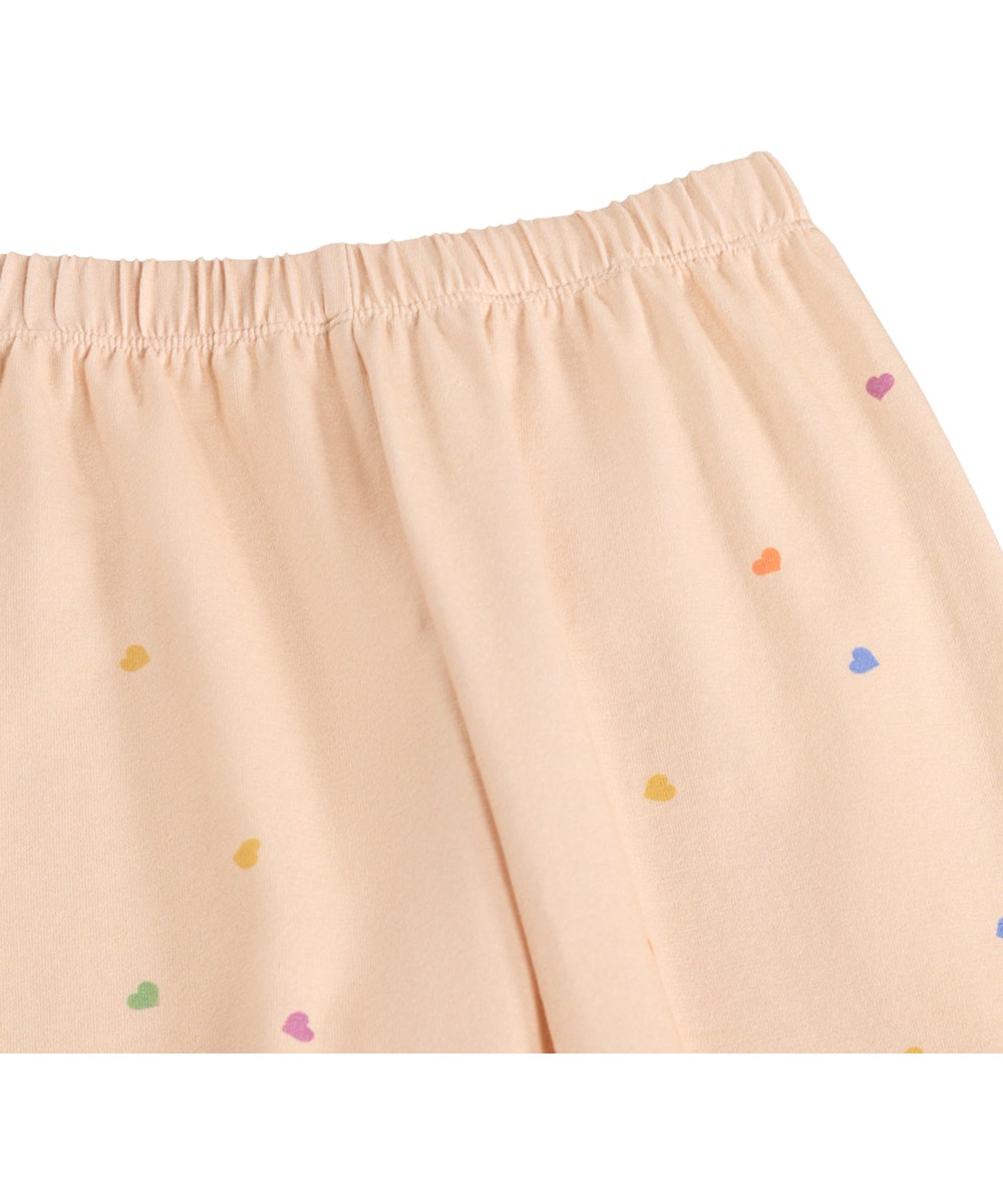 Selena - Confetti - Pink trousers for the little ones made of organic cotton with a heart print 