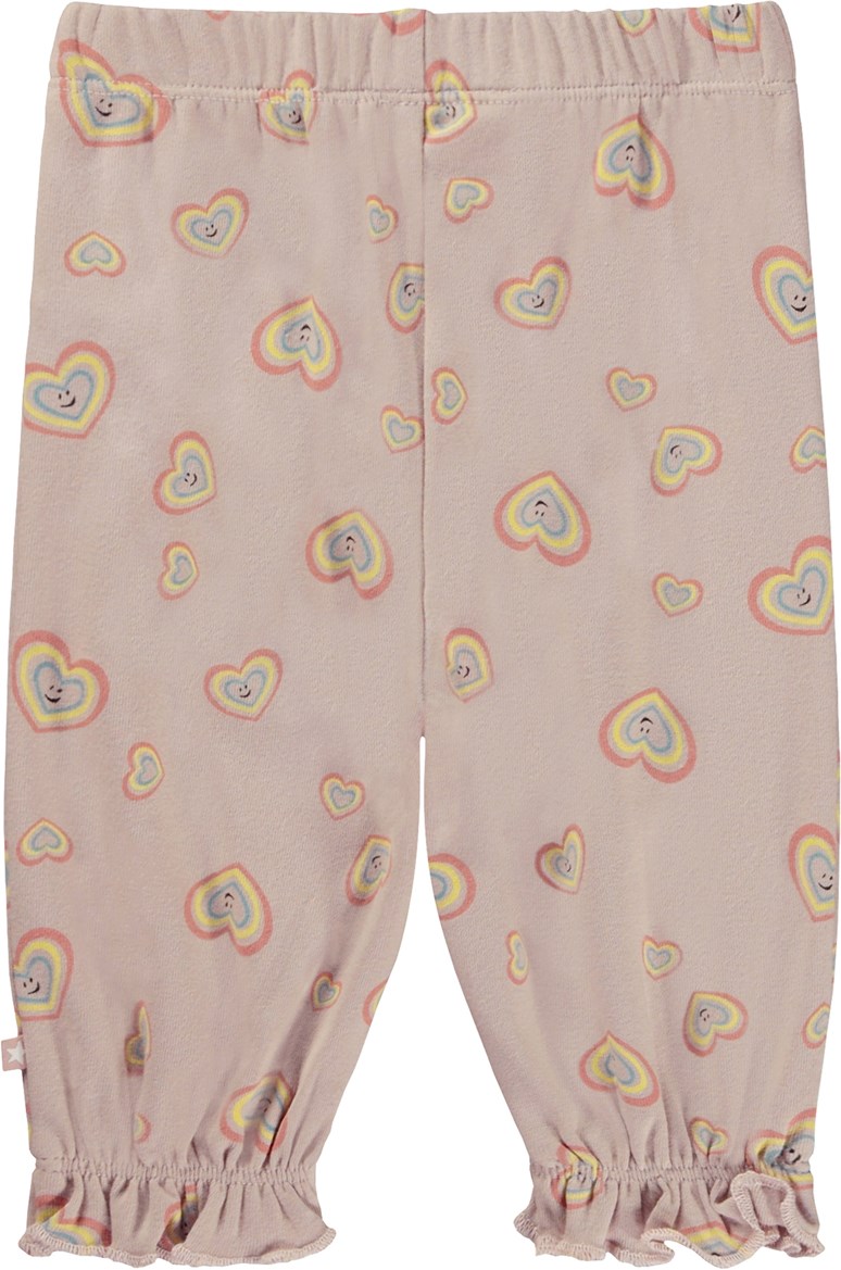 Selena - Mini Aura Hearts - Pink baby trousers with smiling heart print 