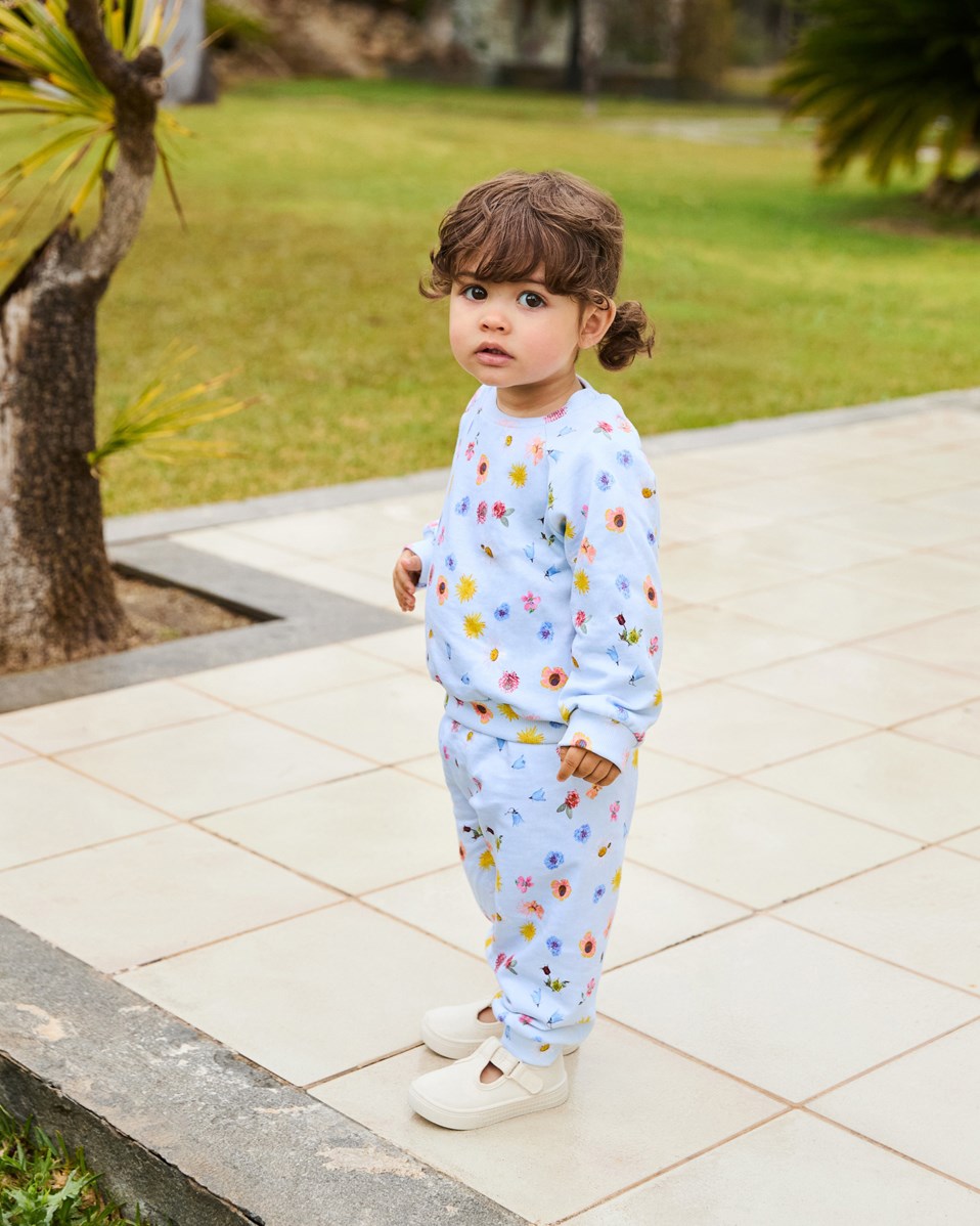 Simeon - Small Flowers Baby - Soft pants in organic cotton for baby. The trousers are light blue with a floral print.