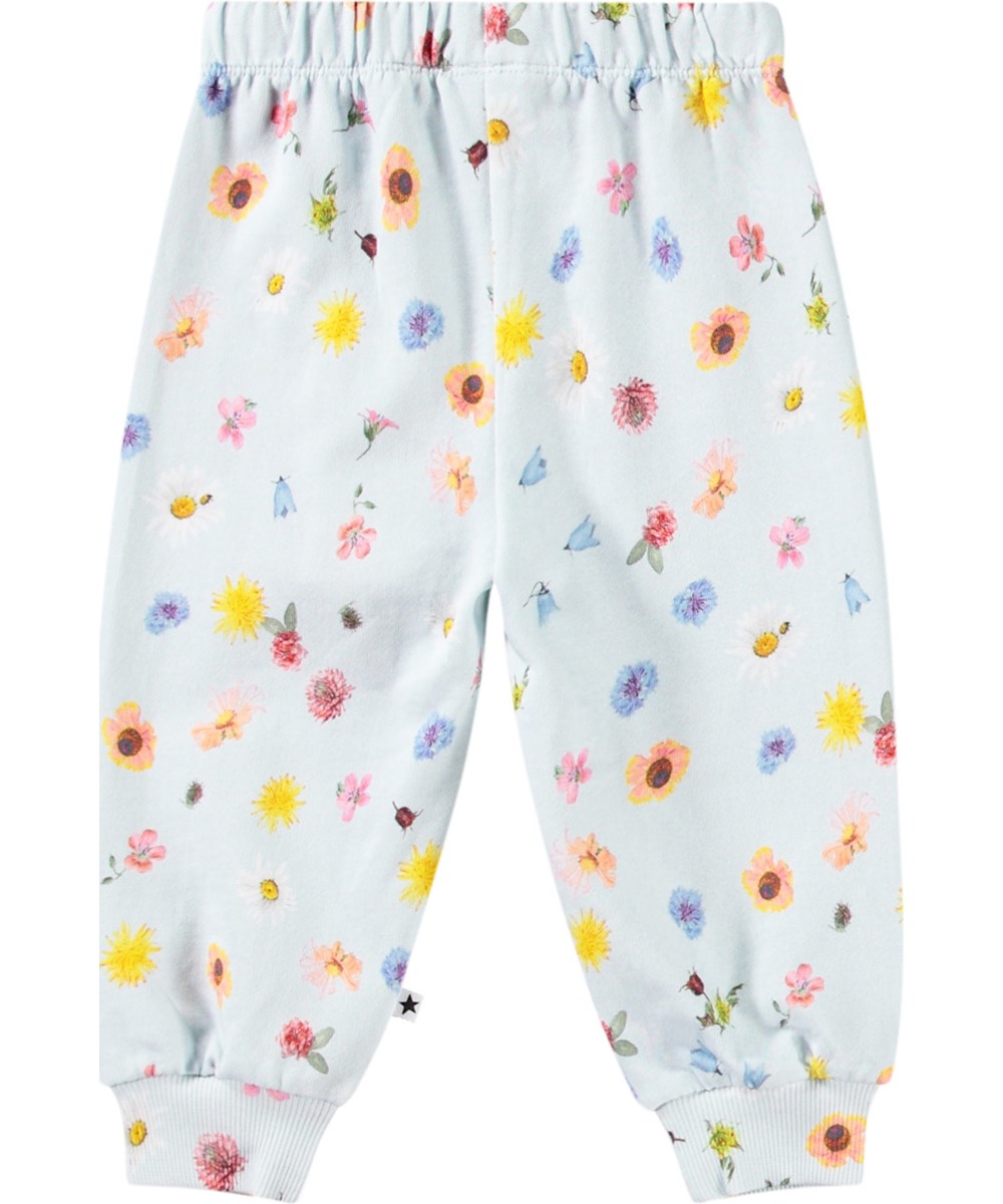 Simeon - Small Flowers Baby - Soft pants in organic cotton for baby. The trousers are light blue with a floral print.