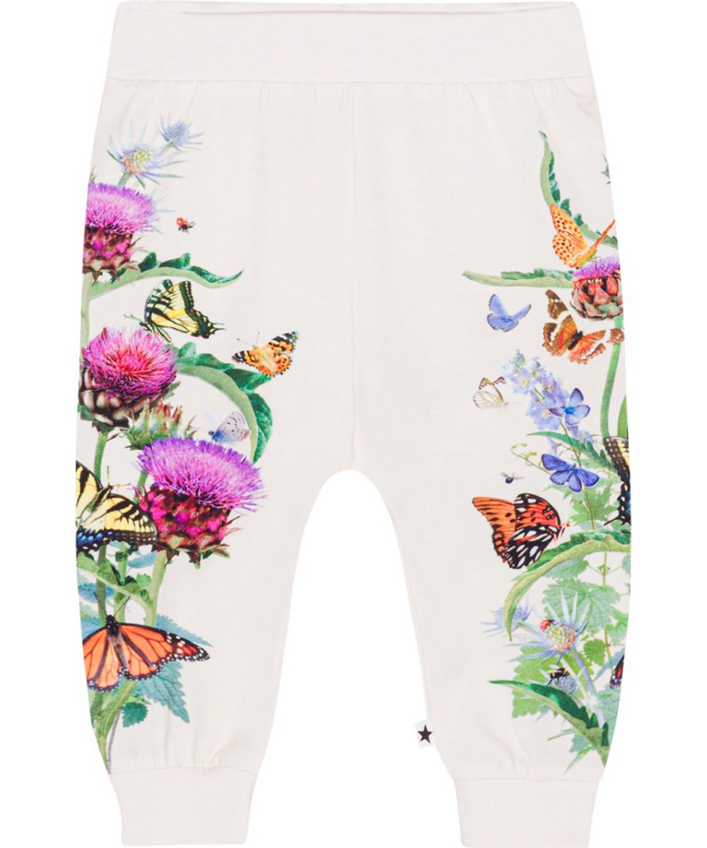 Susanne - Garden Pants - Off-white jersey trousers for small children in organic cotton with a print of purple and red artichoke flowers with colourful butterflies