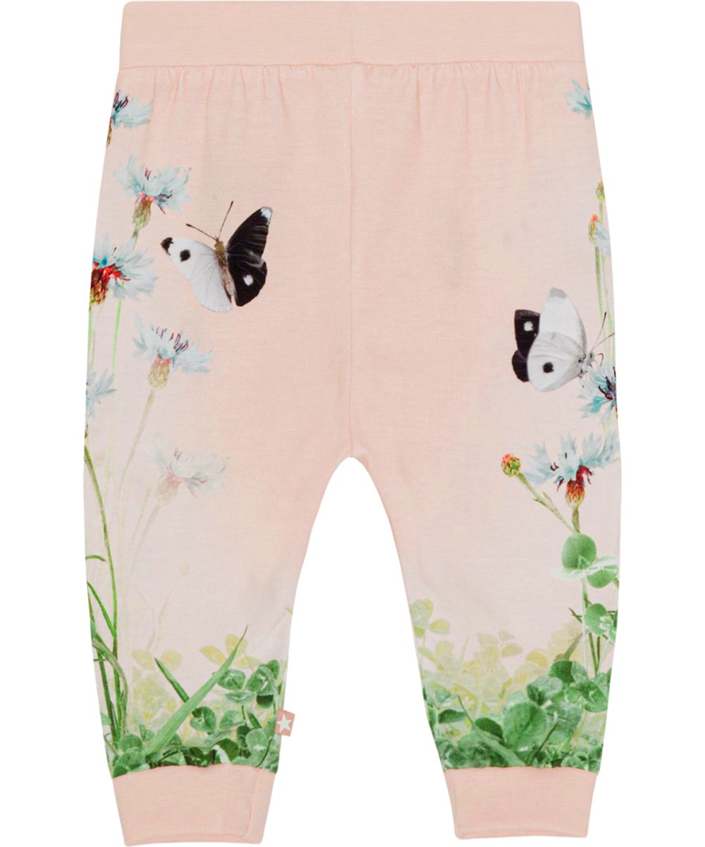 Susanne - Kitten Pants - Pink jersey trousers for small children in organic cotton with a print of a field of clovers with black and white butterflies 