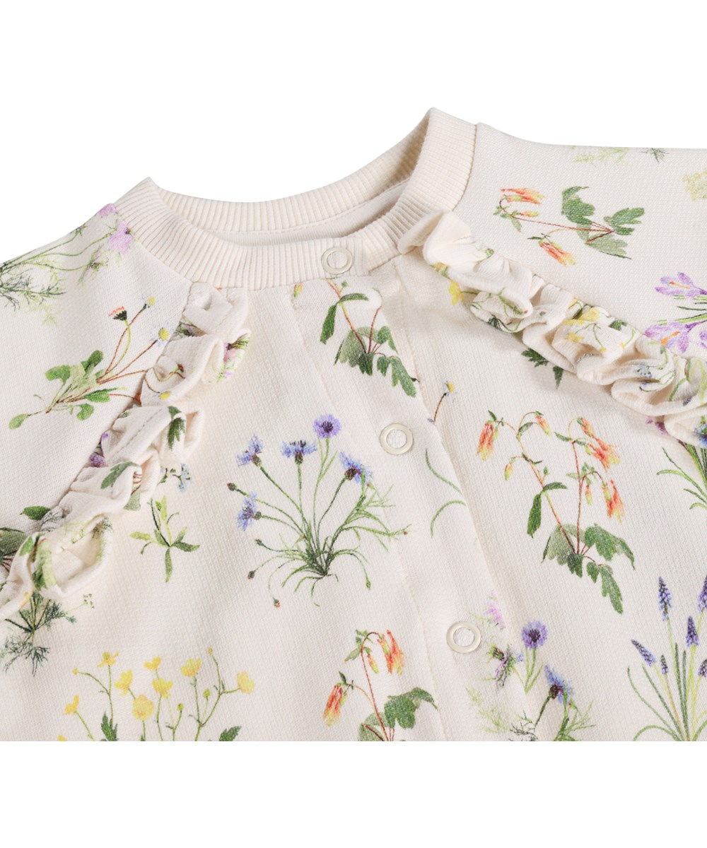 Daphne - Primavera - White cardigan for the little ones made of  organic cotton with a floral print and ruffles