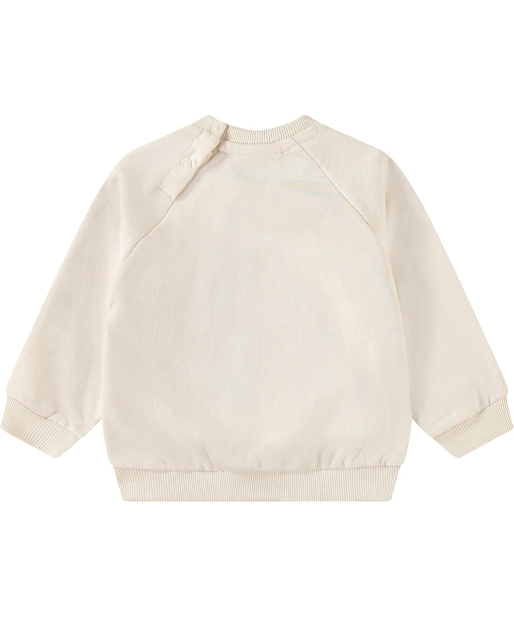 Disc - Jungle Heart - Organic cream-coloured baby sweatshirt with green print of spray-painted smiling heart.