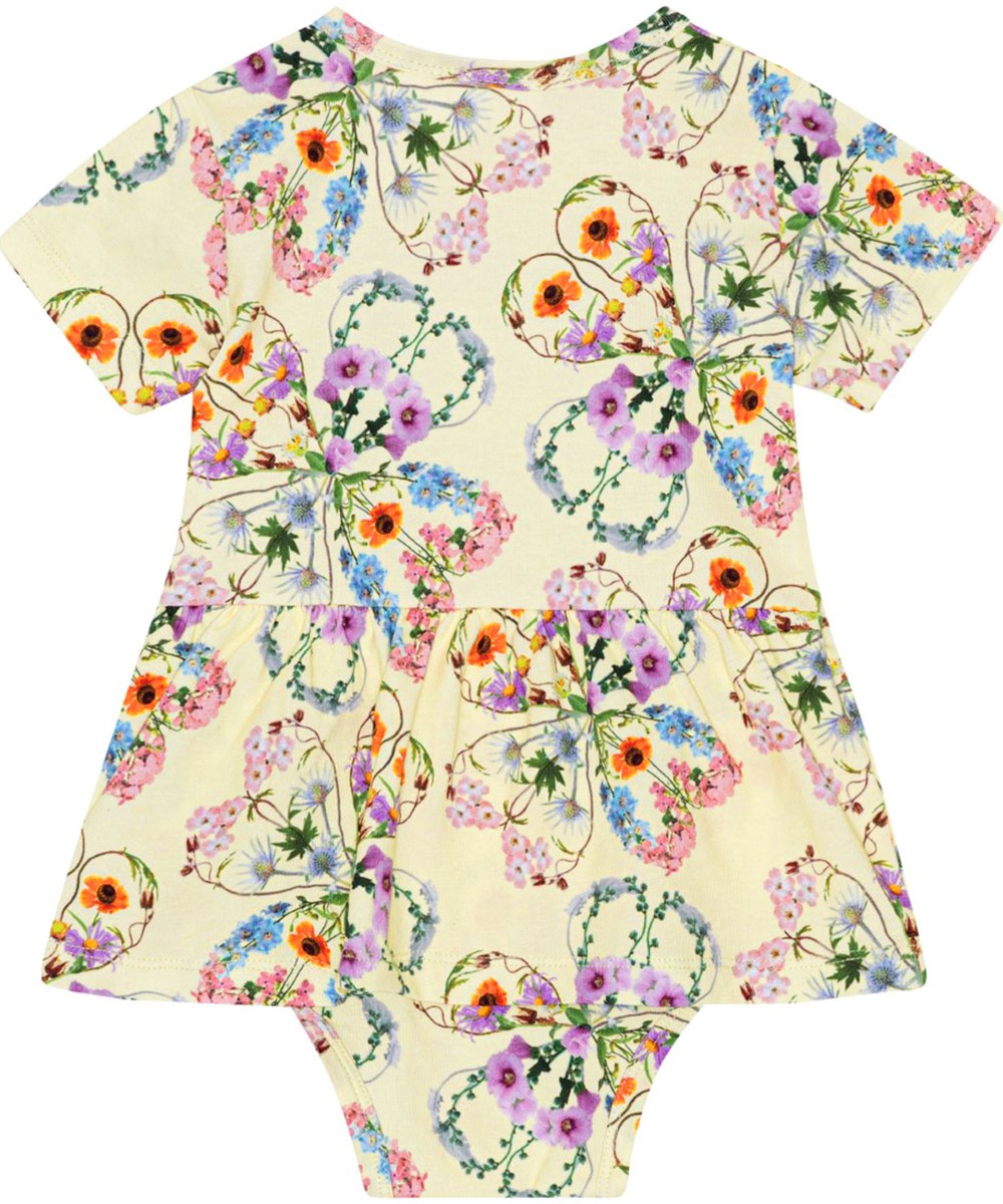 Frannie - Flower Love - Kurzärmliger gelber Baby-Body aus Öko-Stretch-Baumwolljersey mit einem Aufdruck aus bunten Blumen, die wunderschöne Kleeblatt-Silhouetten bilden