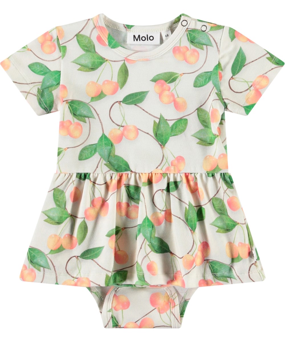 Frannie - Sweet Cherries - Hellfarbener Body aus Öko-Baumwolle. Kurzärmelig für Babys mit Schößchenrock und Kirschendruck.