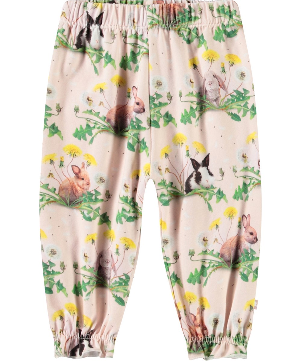 Selena - Bunnies United - Hose aus Öko-Baumwolle für Babys mit einem Druck von Hasen und Löwenzahn.