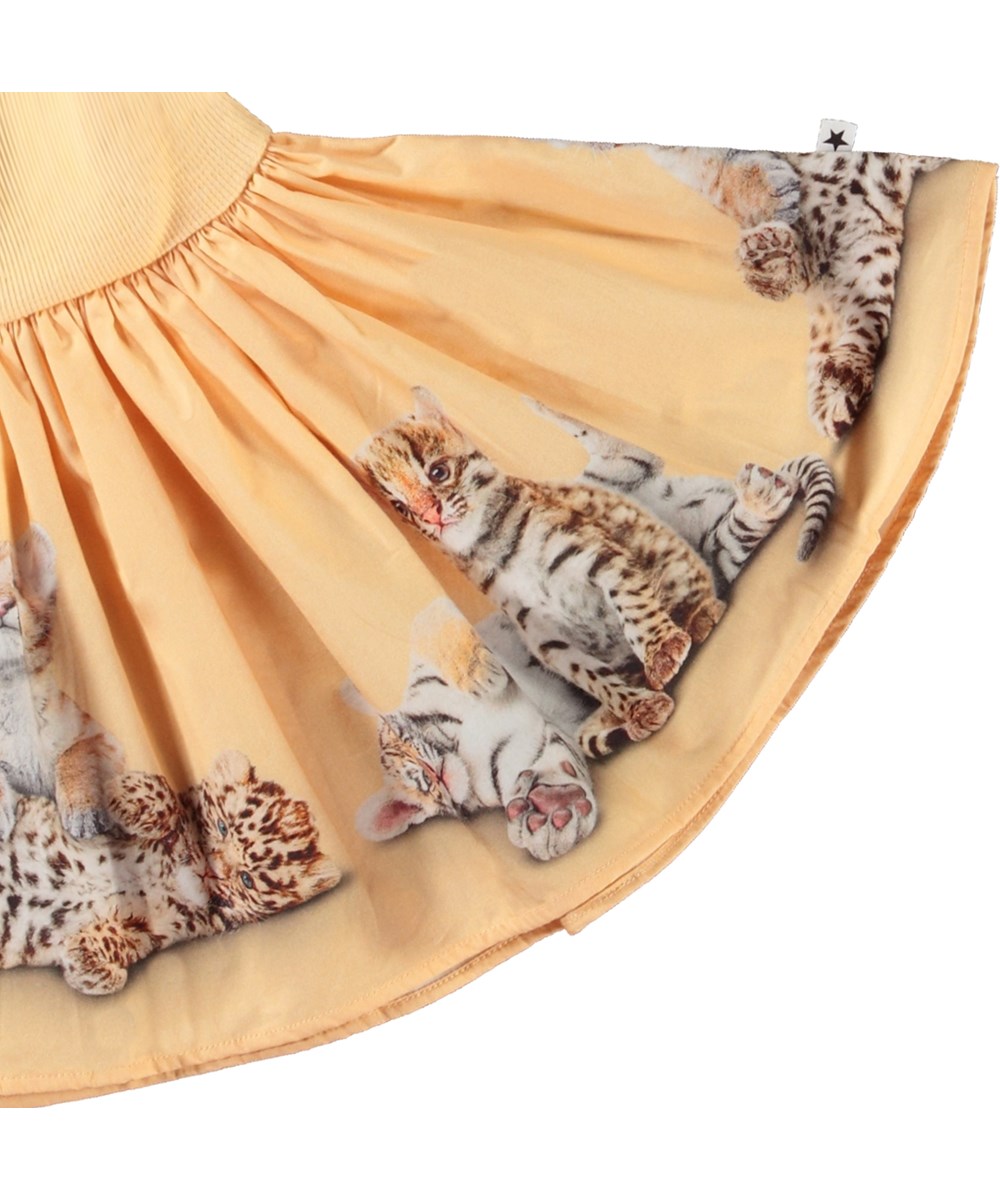 Carin - Cubs United - Kleid für Baby aus Öko-Baumwolle. Das Kleid ist hellorange mit einem Aufdruck von Tierjungen.