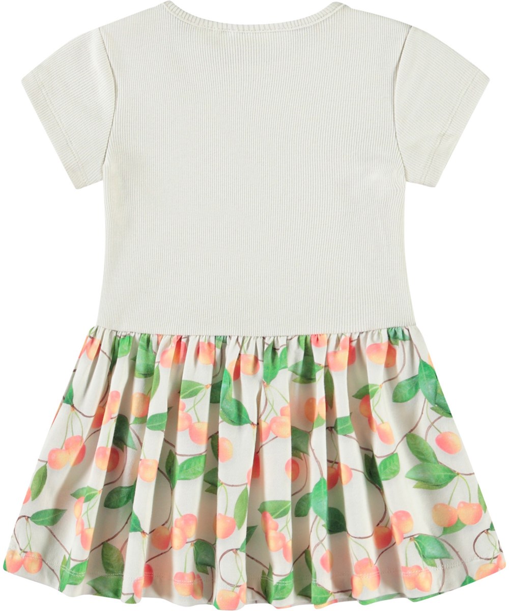 Catja - Sweet Cherries - Kleidung aus Öko-Baumwolle für Babys. Das Kleid ist weiß mit einem Kirschendruck.