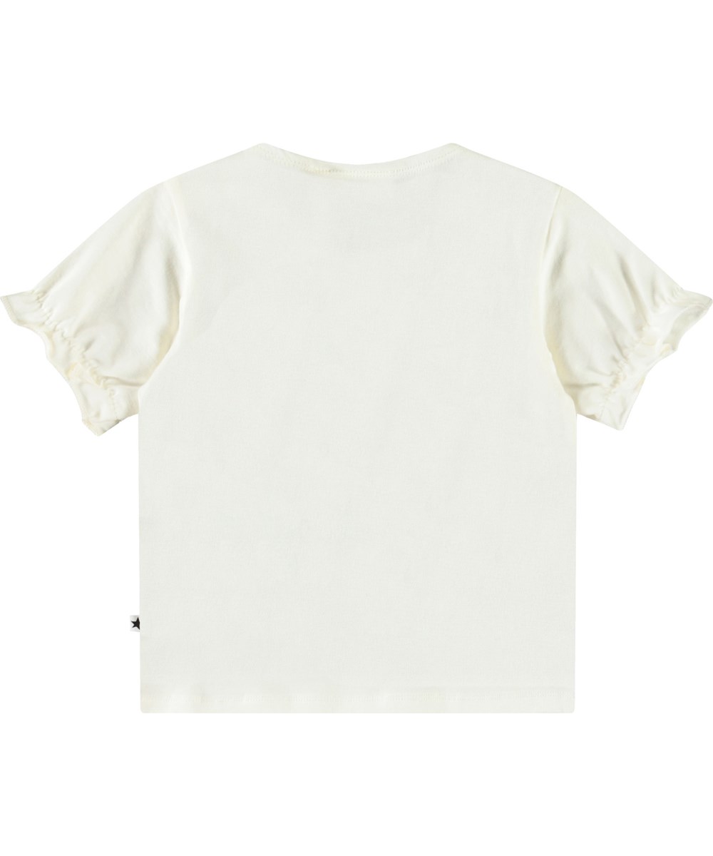 Eline - Love Birds - T-Shirt mit Rüschen-Details aus Öko-Baumwolle für Babys. Weiß mit einem Frontdruck von kleinen Papageien und Kirschen.