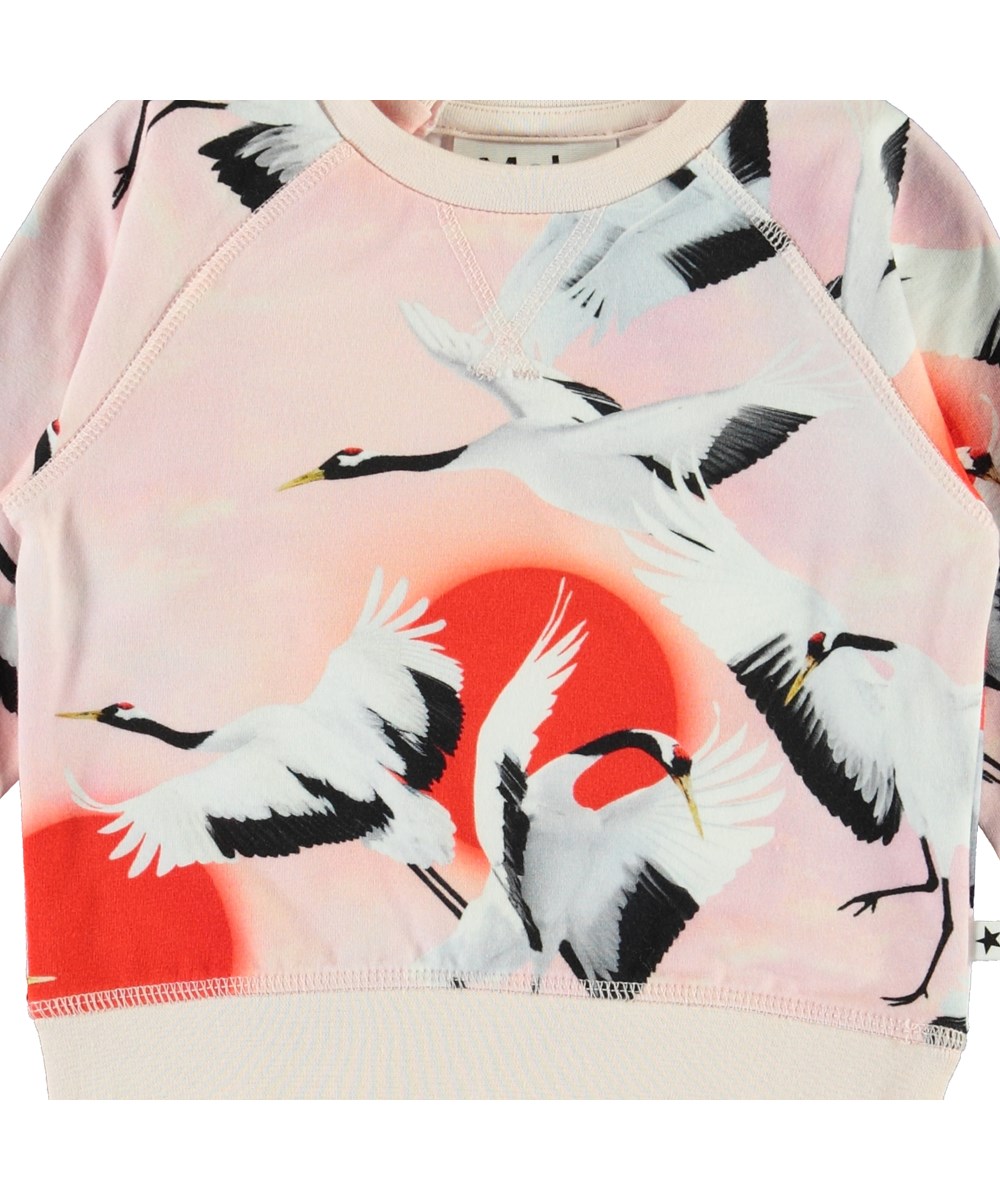 Elsa - Sunrise Cranes - Öko-Babybluse mit Vögeln