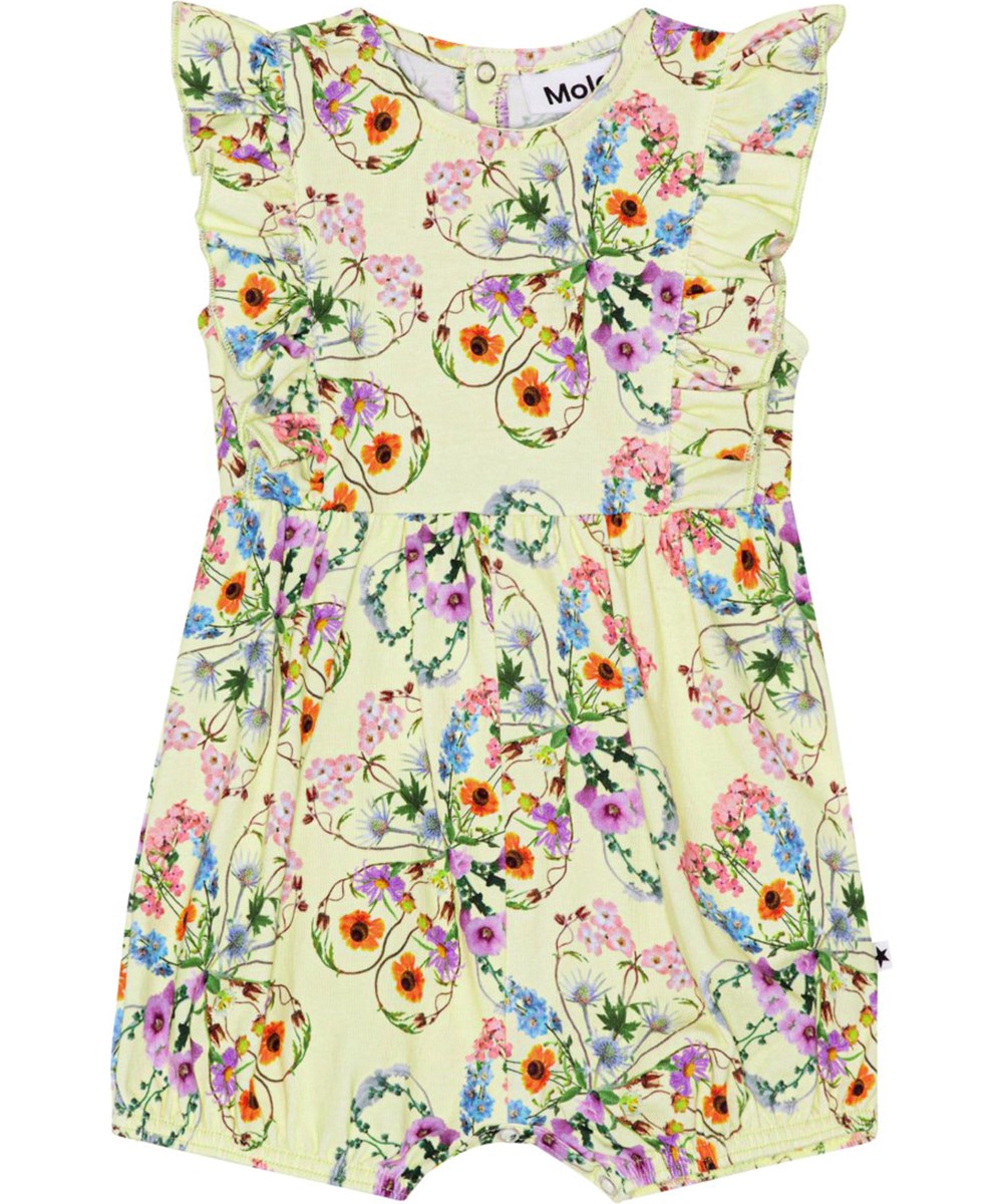 Felicia - Flower Love - Gele jersey babypakje met prachtige ruches op de voor- en achterkant met een print van kleurrijke bloemen die prachtige silhouetten van klavertjes vormen