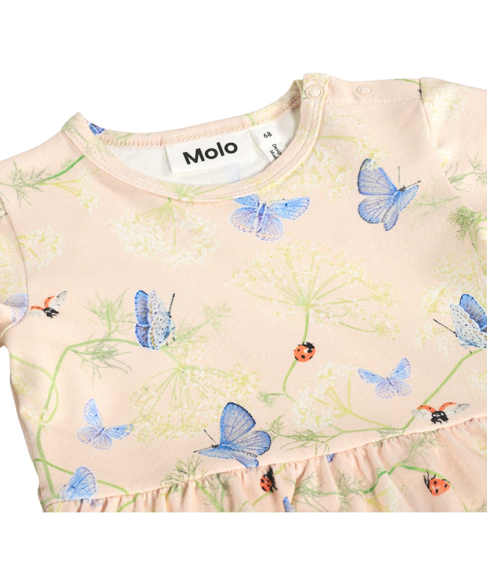 Frannie - Butterflys Cloud - Lichtroze, kort mouwloos jurkje voor de kleintjes gemaakt van biologisch katoen met aangehecht rompertje en vlinderprint.
