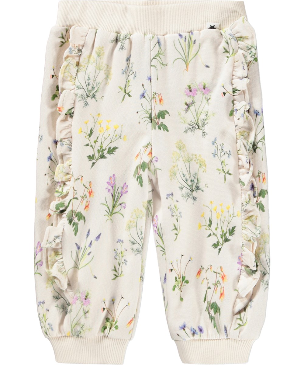 Sallie - Primavera - Witte broek voor de kleintjes gemaakt van biologisch katoen met een bloemenprint en ruches.